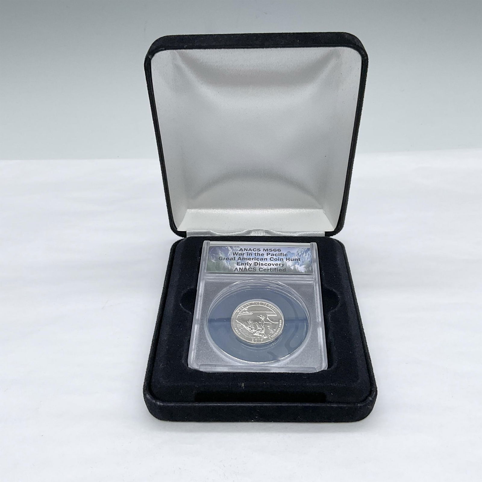 2019-W War In The Pacific (Guam) U.S. Quarter ANACS MS66 Great Am. Coin Hunt: Slabbed and Graded MS66, Great American Coin Hunt Early Discovery. The obverse side depicts the usual design of George Washington's profile. The reverse side, which frequently changes, depicts America