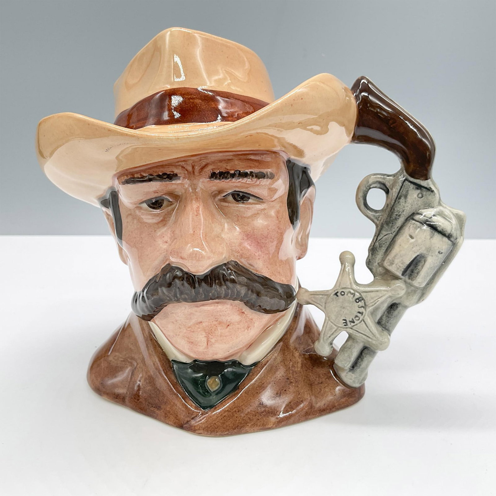 Wyatt Earp D6711 - Odd Size - Royal Doulton Character Jug: Royal Doulton backstamp. Artist: Stanley J. Taylor Issued: 1985 - 1989 Dimensions: 5.5"H Manufacturer: Royal Doulton Country of Origin: England