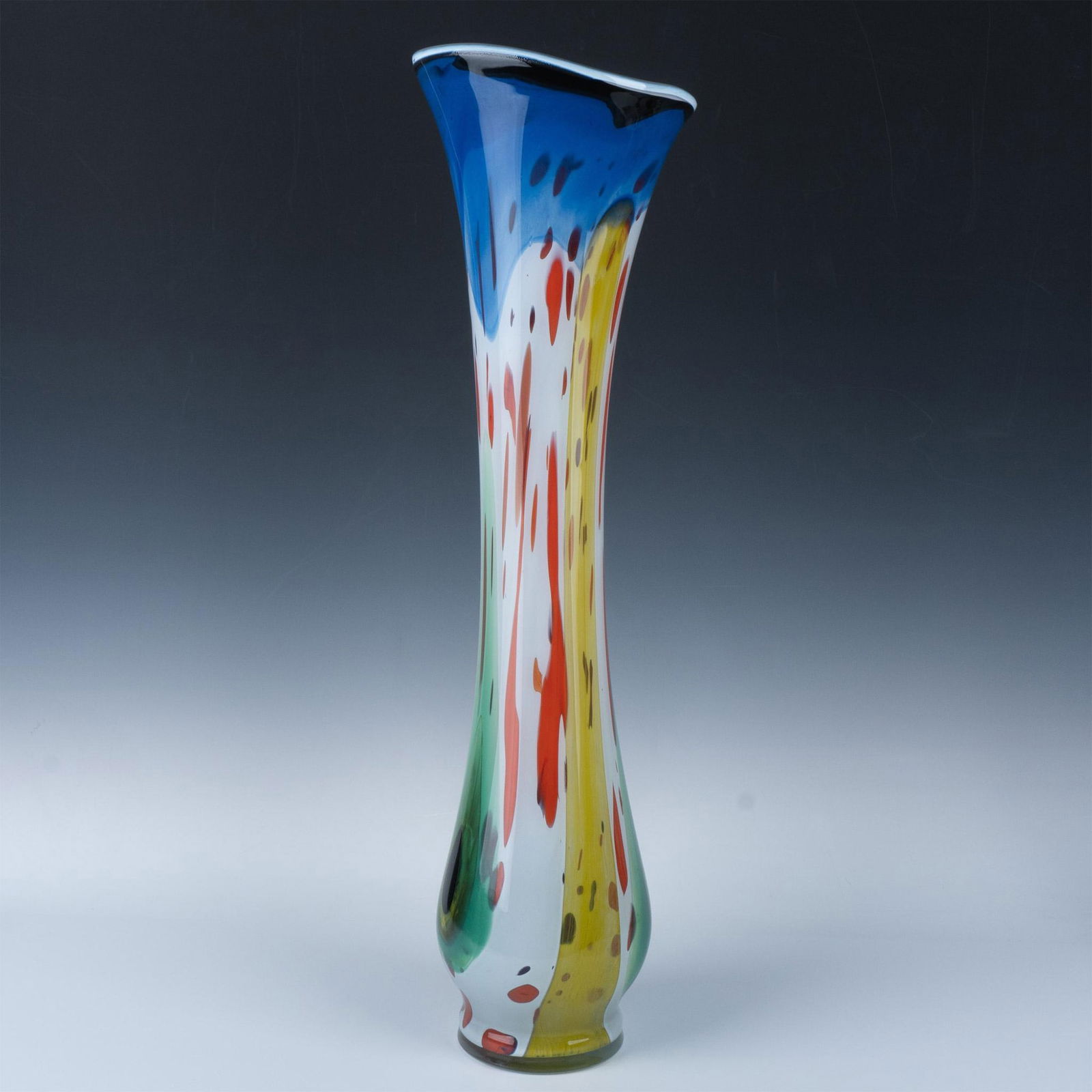 Mihai Topescu Romanian Art Glass Vase: A tall slender abstract vase with a flare rim. Beautifully features an array of glass colors; blue, green, yellow, red, white and black. Mihai Topescu sticker and signed. The measurements are approxim
