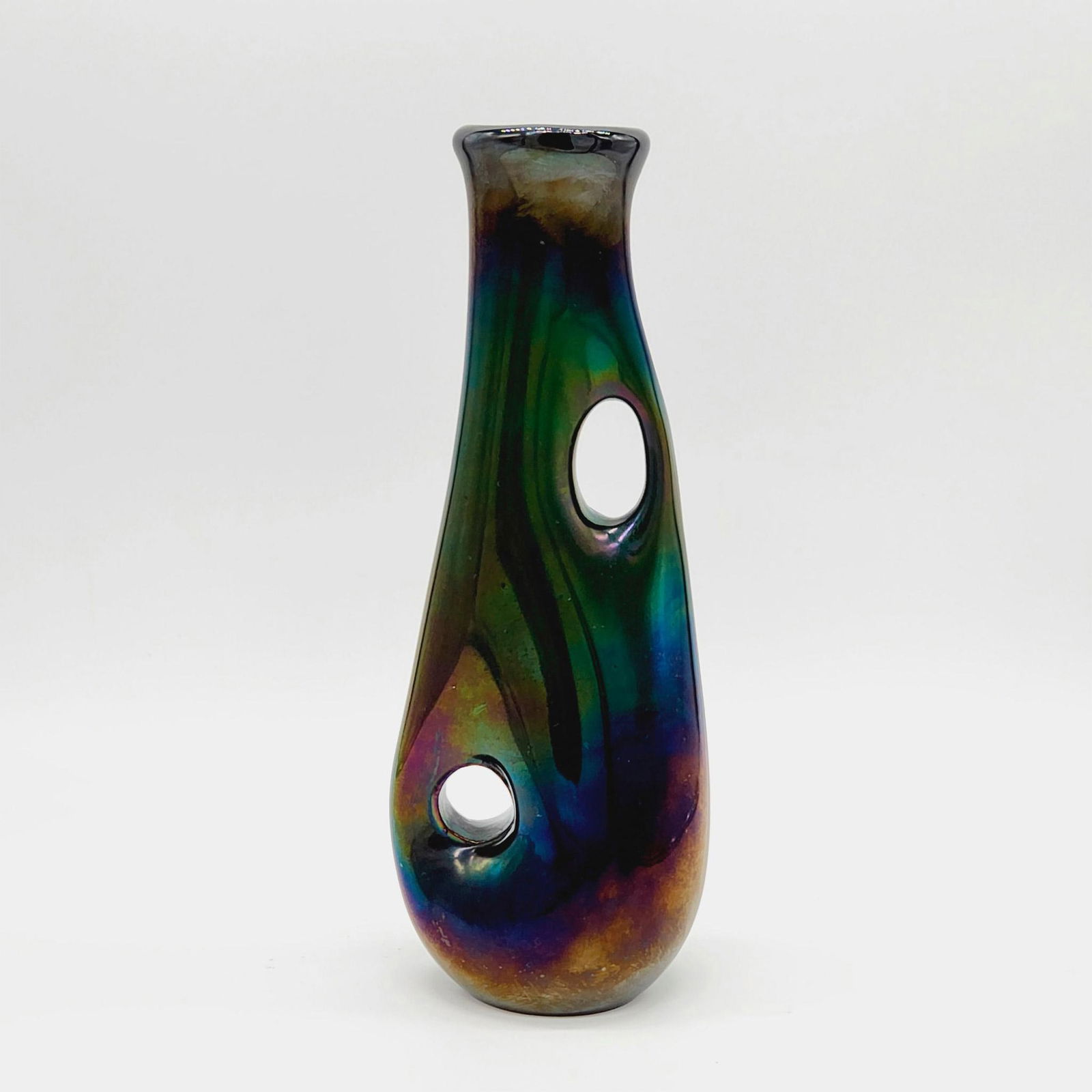 A.Ve.M. Murano Glass by Giorgio Ferro Vase, Anse Volanti: Iconic series designed by Giorgio Ferro (Italian, b. 1931). A small green and iridescent vase with two holes in the body. Vase approximately: 9.75"H. Artist: Giorgio Ferro Issued: 1950s Dimensions: Se
