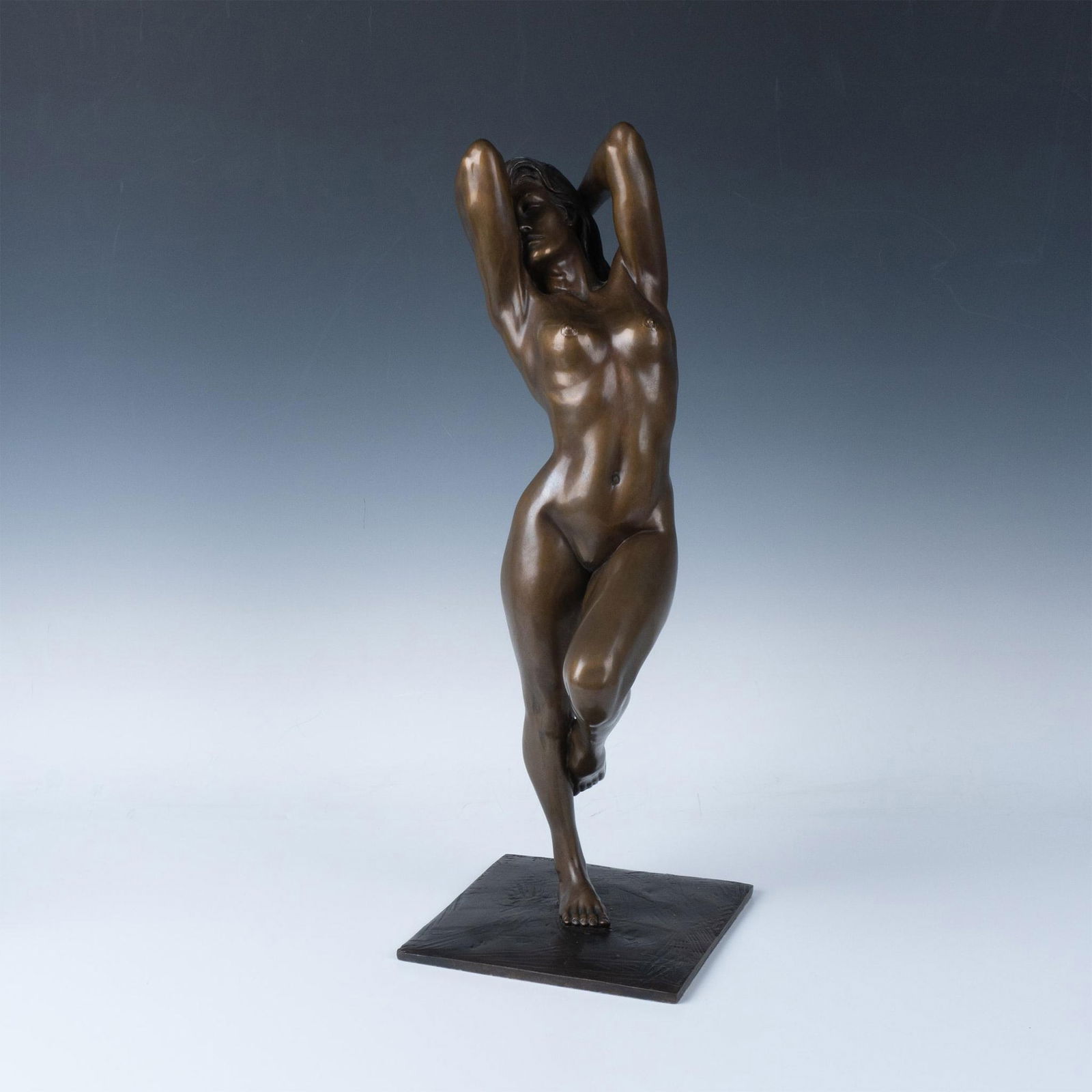Bill Mack Trial Proof Bronze Nude Sculpture, Charisma: Trial Proof 1 of 5. Designed by Bill Mack, American, born in 1949. A beautiful nude sculpture of a beauty standing on one foot with hands in her long hair. Marked: TP 1 of 5, artist signature and date