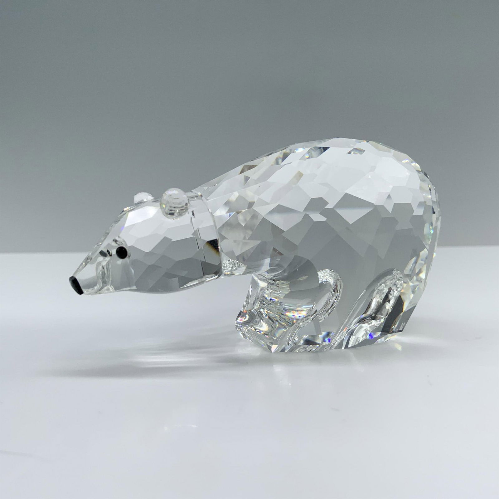 Swarovski Crystal Figurine, Polar Bear 013747: A large, round polar bear standing sturdily with its head held high, showcasing its striking black crystal eyes. Swarovski backstamp. This item has its original box. Box measures: 4"H x 5" dia. Artist