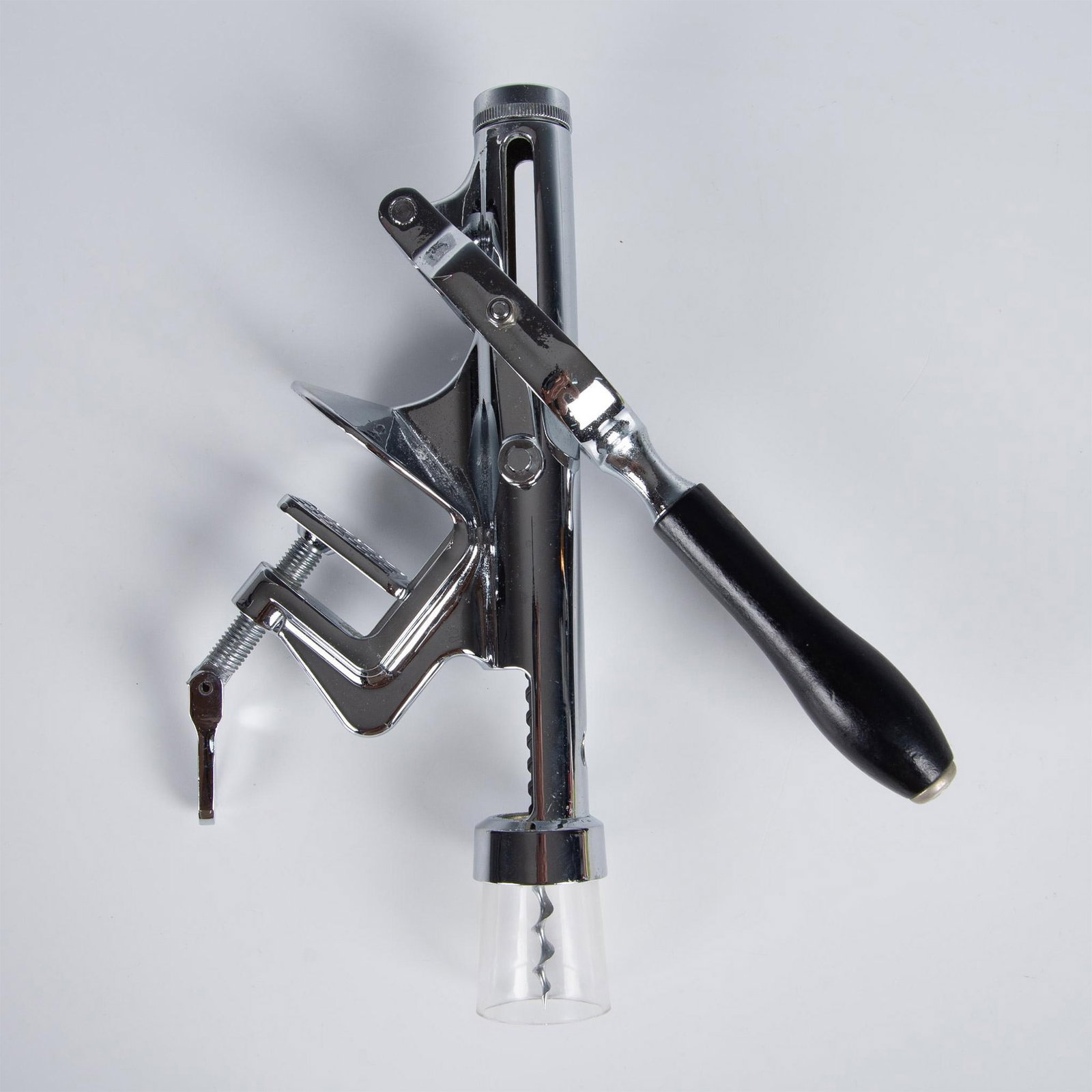Chrome Plated Table-Bar Mounted Wine Bottle Opener: Heavy duty opener intended to be attached to a tabletop or bar counter. Black wood covers lever handle. Issued: 20th century Dimensions: 13"L x 11"W x 2.75"H
