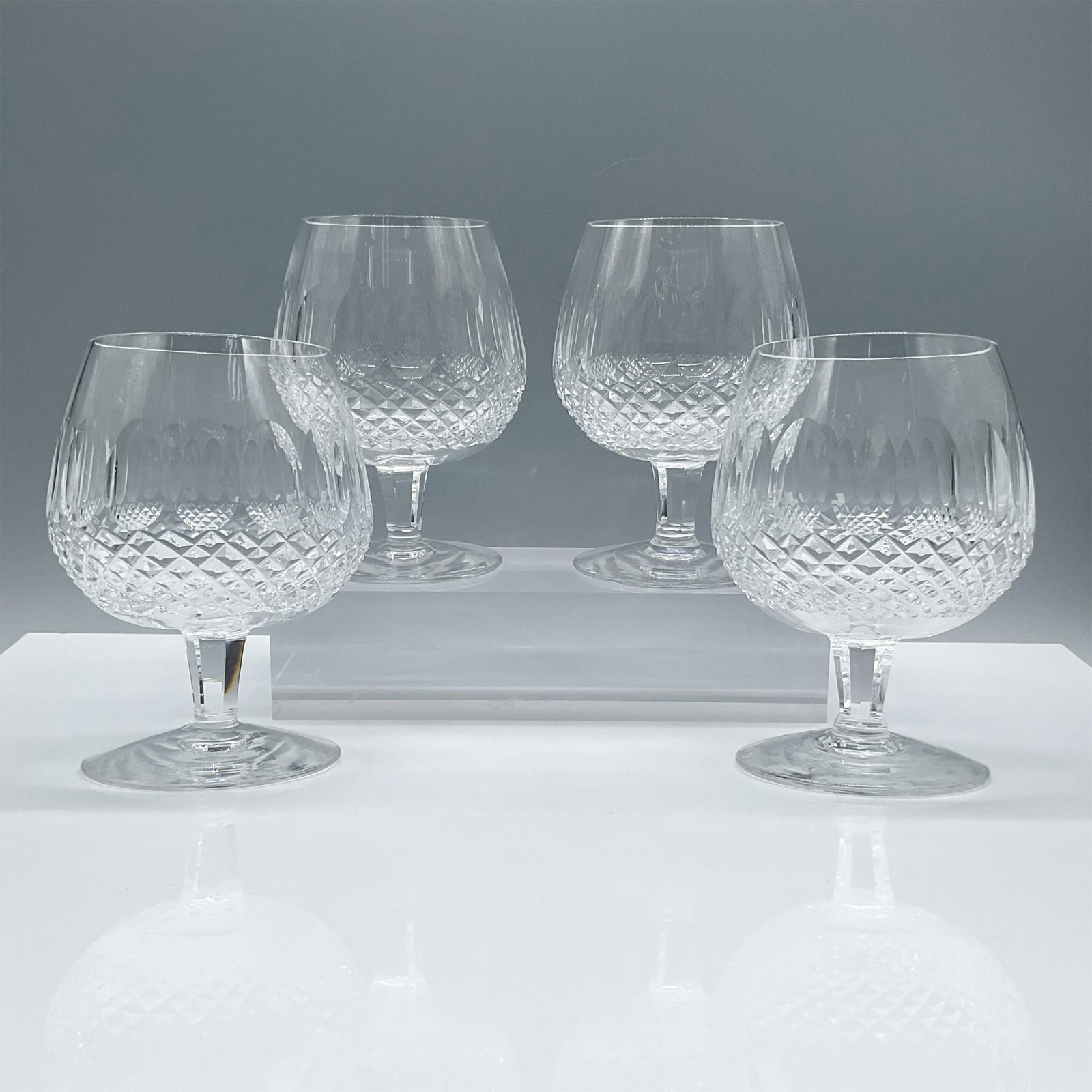 4pc Waterford Crystal Large Brandy Glasses, Colleen: Beautiful clear crystal in the Colleen patten with short stem. Creates a beautiful light effect accenting its brilliance. Waterford acid mark. Issued: 20th century Dimensions: 5''H x 3.25''dia, each M