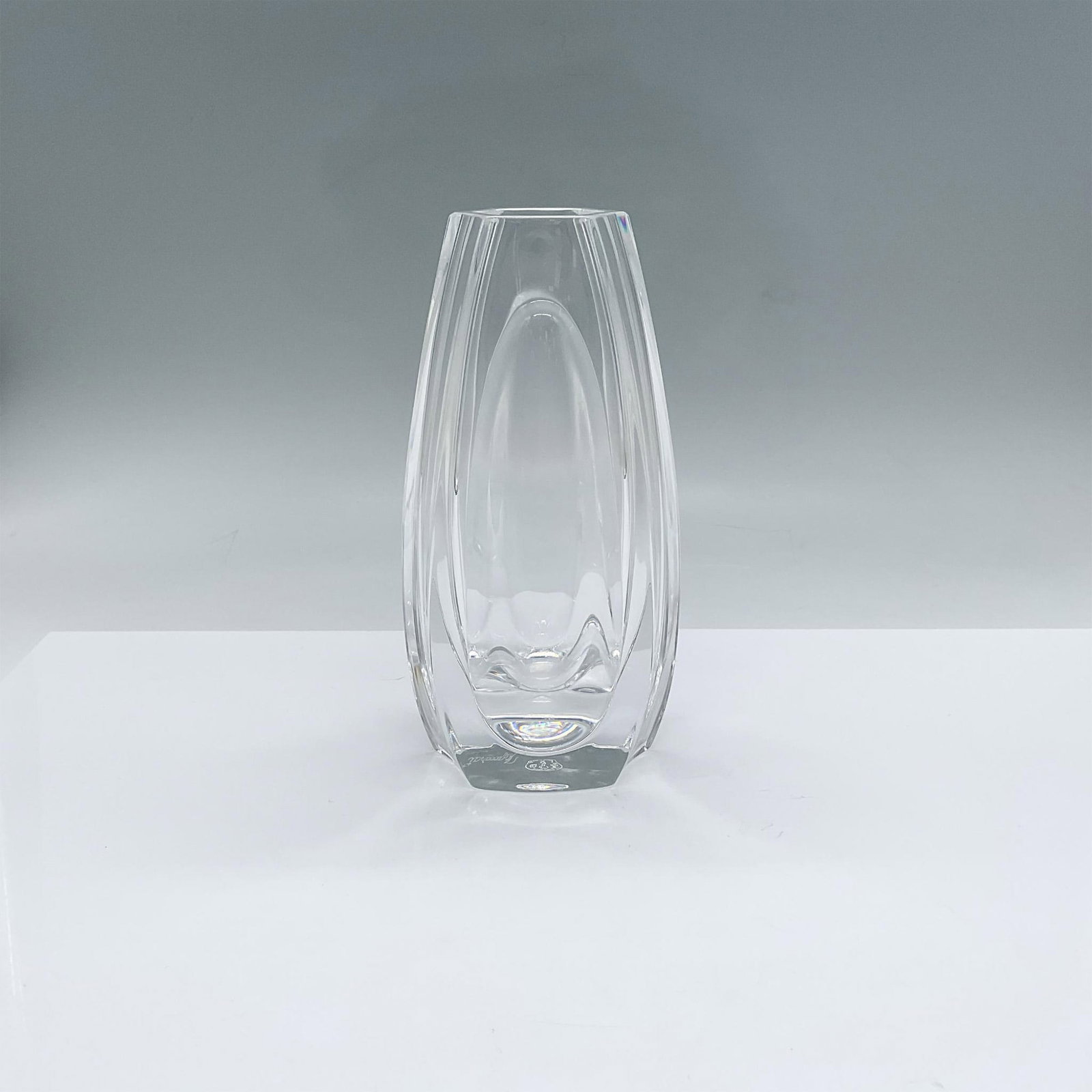 Baccarat Crystal Vase: Elegant small crystal vase with smooth, rounded lines. Baccarat etched backstamp. This item has its original box measuring 11"L x 4.5"W x 4.5"H. Artist: R. Rigot Issued: 20th century Dimensions: 3.5"L