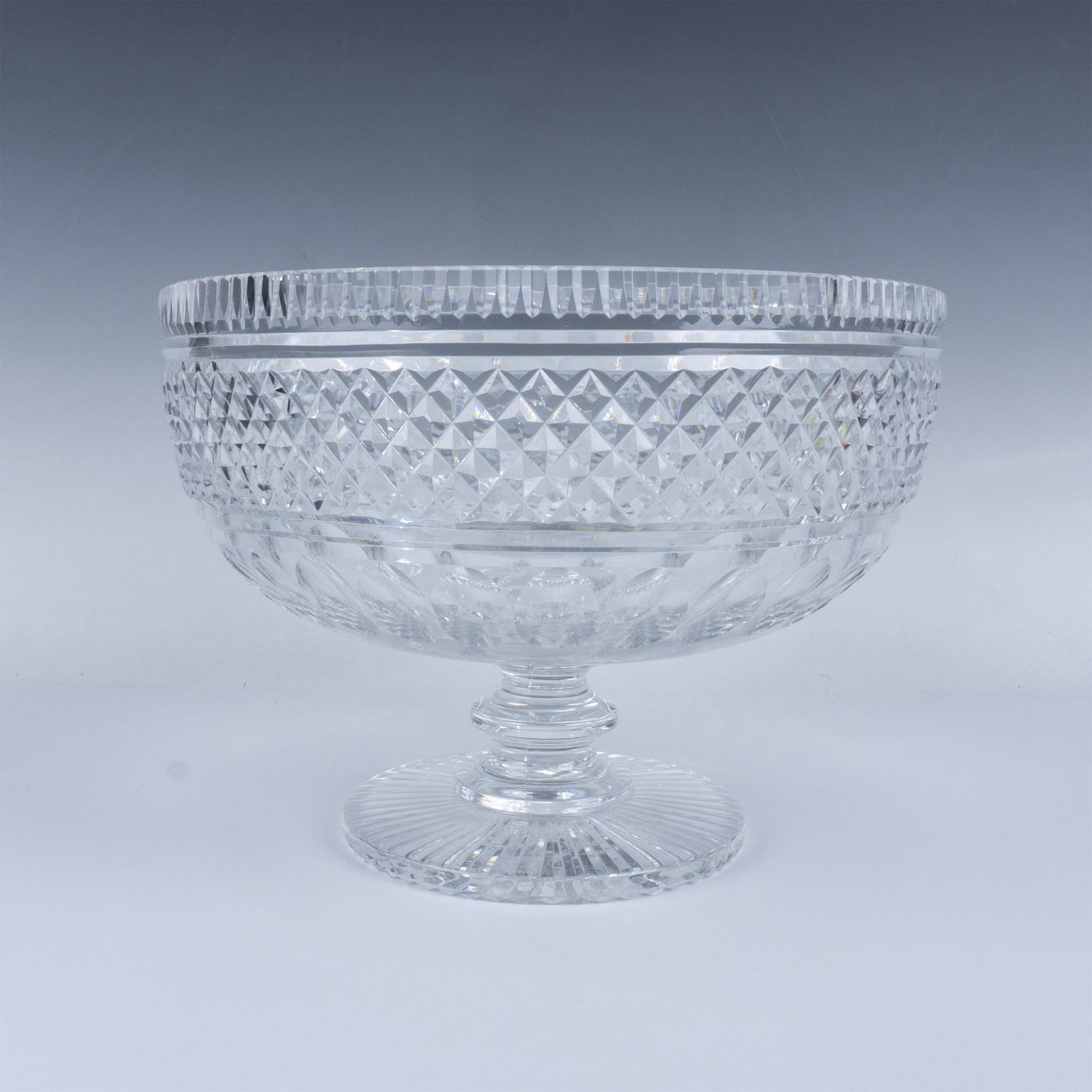 Crystal Footed Centerpiece Bowl: Dazzling clear crystal, featuring an intricate pattern design and a circular pedestal base. Unmarked. Issued: 20th century Dimensions: 7.75''H x 10.75''dia Manufacturer: Waterford Country of Origin: I