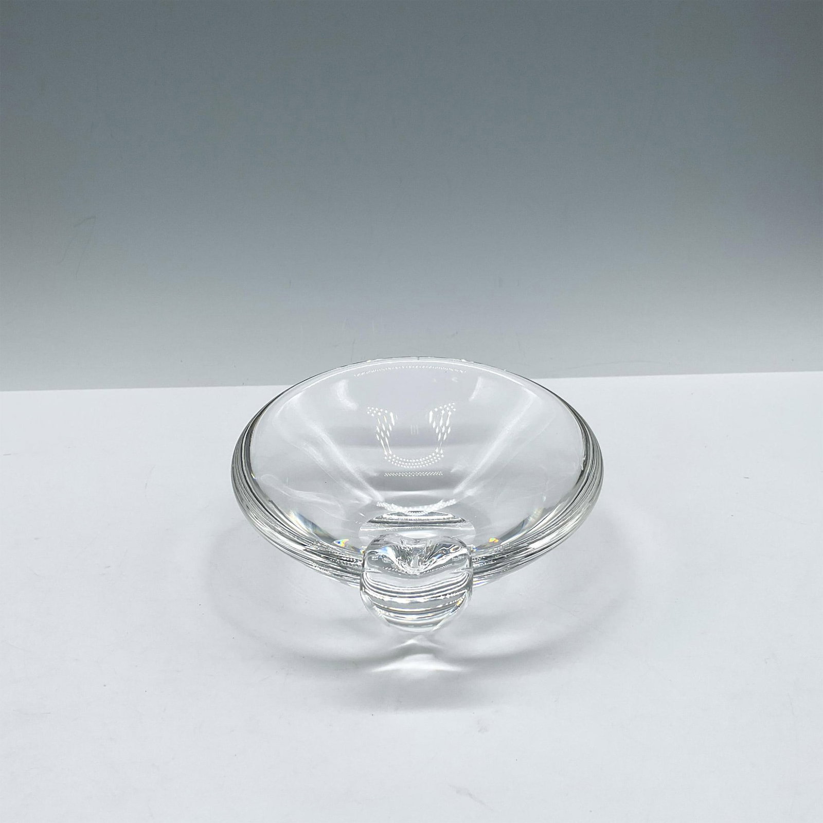 Steuben Art Glass Ashtray: Mid-century modern styled glass with simple, clean lines. Steuben etched mark. Artist: George Thompson Dimensions: 2"H x 5" dia. Manufacturer: Steuben Country of Origin: United States