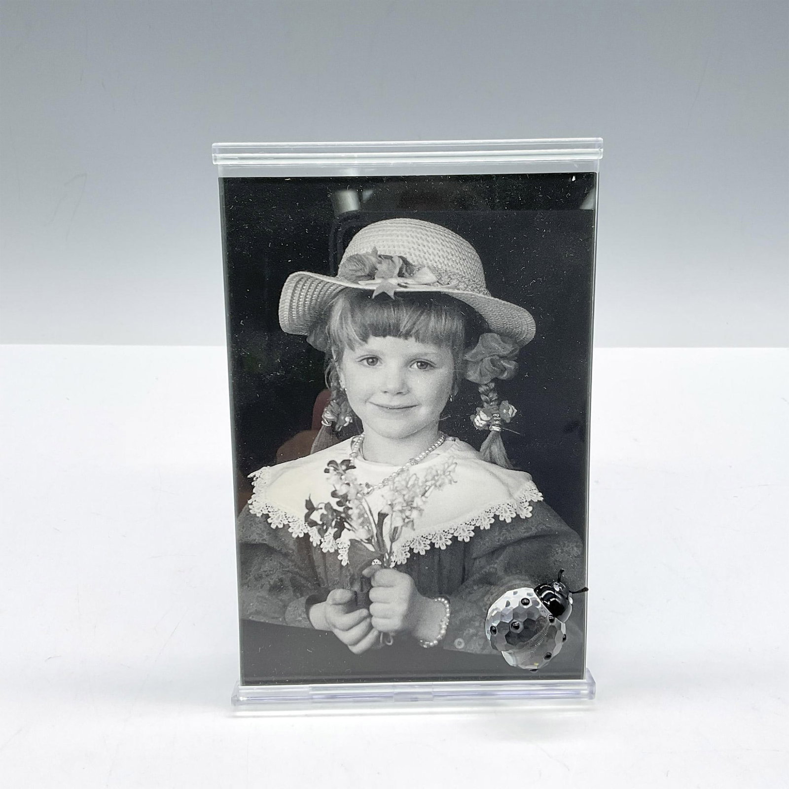 Swarovski Silver Crystal, Picture Frame with Ladybug: Part of the Exquisite Accents theme group this 3 x 5 frame is adorned with crystal ladybug. Swarovski impressed mark. 211739. This item has its original box: 7.5"L x 8"W x 3.5"H. Issued: 1997 - 2000 D