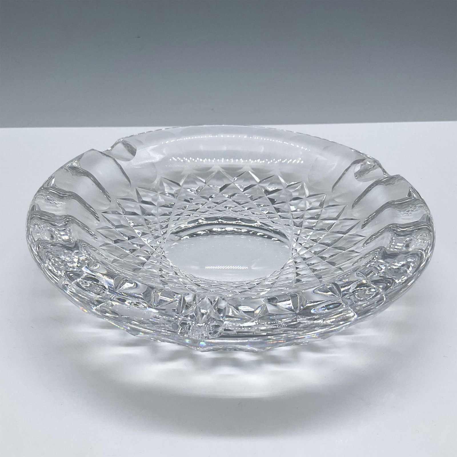 Waterford Crystal Ashtray, Colleen: Beautiful clear crystal with a wide shape in the colleen cut pattern. Waterford acid backstamp. Issued: 20th century Dimensions: 1.5''H x 7''dia Manufacturer: Waterford Country of Origin: Ireland