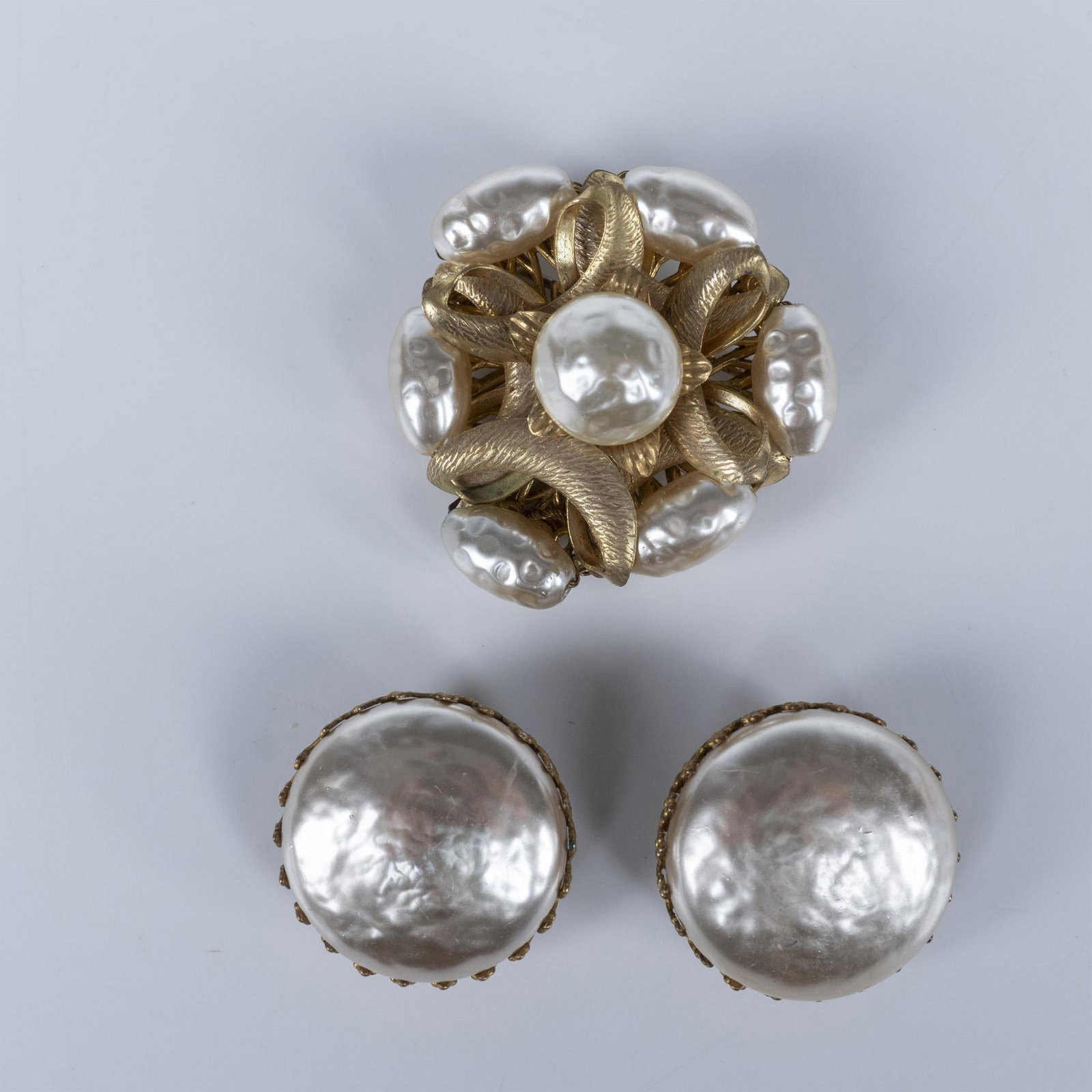 Miriam Haskell Golden Faux Pearl Brooch & Clip Earrings Set: This beautiful set is gold metal with faux pearls. All pieces are marked Haskell. The brooch measures 1.5"L x 1.5"W. The clip-on earrings measure 1"L x 1"W. Issued: 20th c. Dimensions: See Description