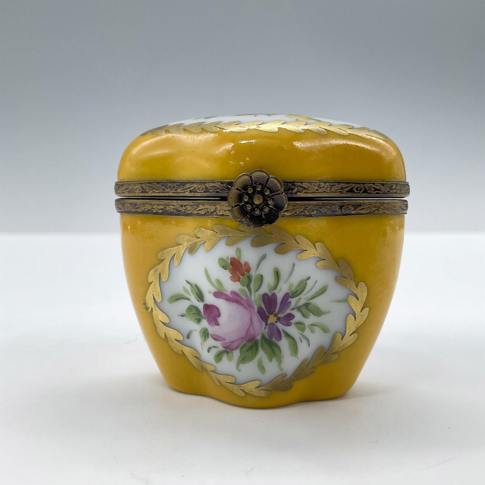 Limoges Porcelain Treasure Box, Yellow Chest: Hand painted in Limoges France. Limited edition. A little chest with painted flowers, gold accents and a metal flower closure. Signed Peint Main Limoges France MB gg 16/50 LL. Issued: 1999 Dimensions: