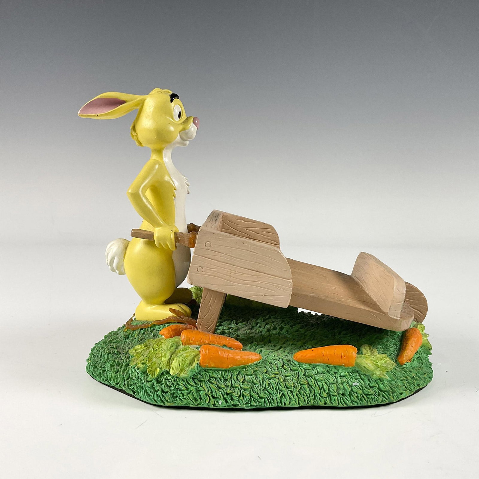 Winne The Pooh & Friends Rabbit Note Pad Holder: A desk decorative figure of a rabbit holding a wheel barrow shaped note pad holder. Dimensions: 6.5"L x 4.25"W x 5.5"H