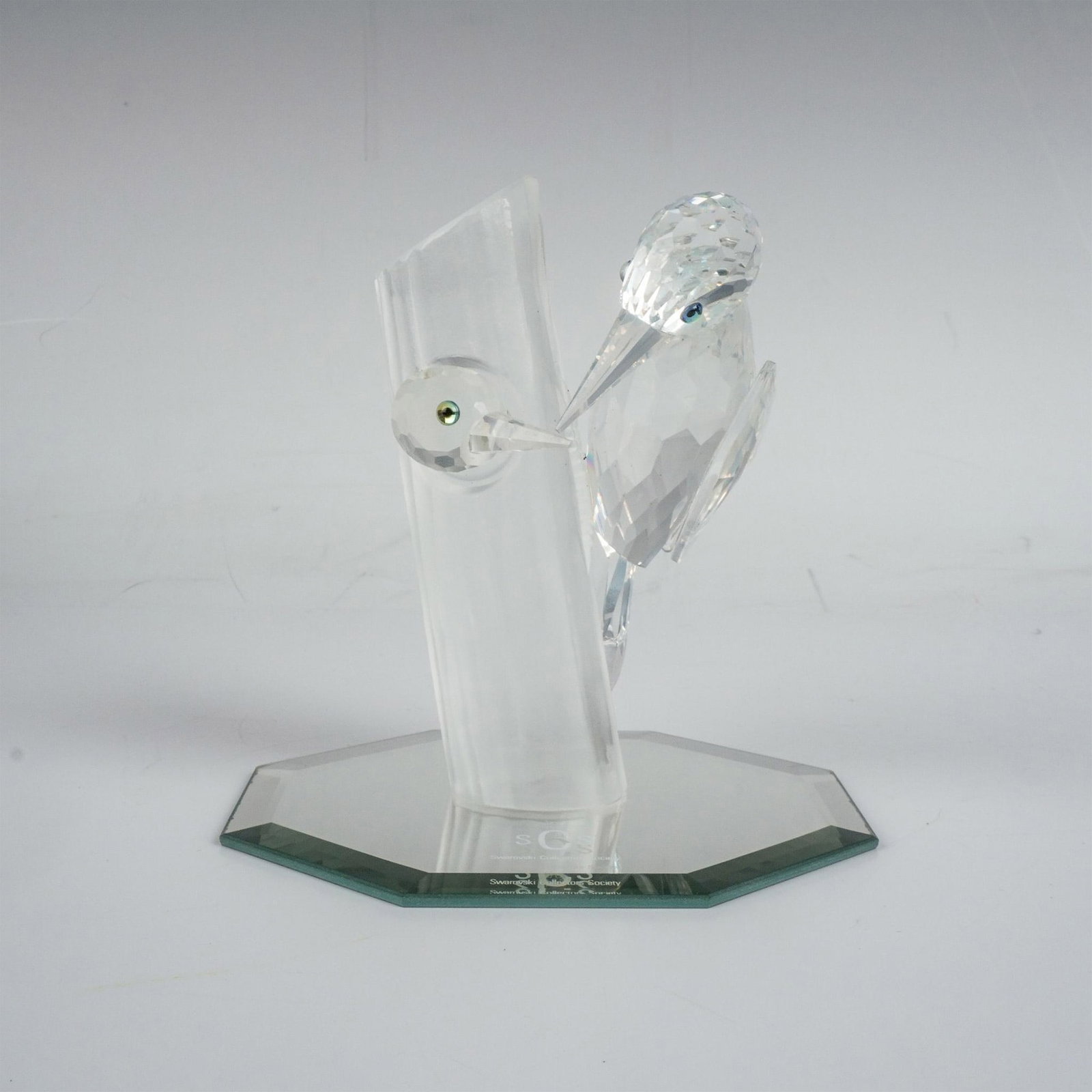 Swarovski Crystal Figurine The Woodpeckers, Sharing + Base: A clear faceted figure of wood pecking birds with iridescent eyes, perched and inside a frosted tree. Part of the 1988 Annual Edition. Swarovski Collectors Society SCS Swarovski marking. This item has