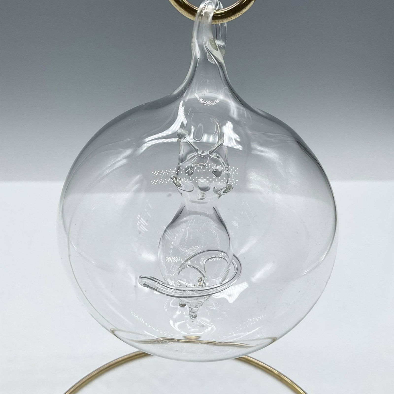 Vintage Blown Art Glass Cat Inside Bulb Ornament: Delicate bulb design of cat in center of clear blown glass ornament. Issued: 20th century Dimensions: 3.5"H x 3" dia.