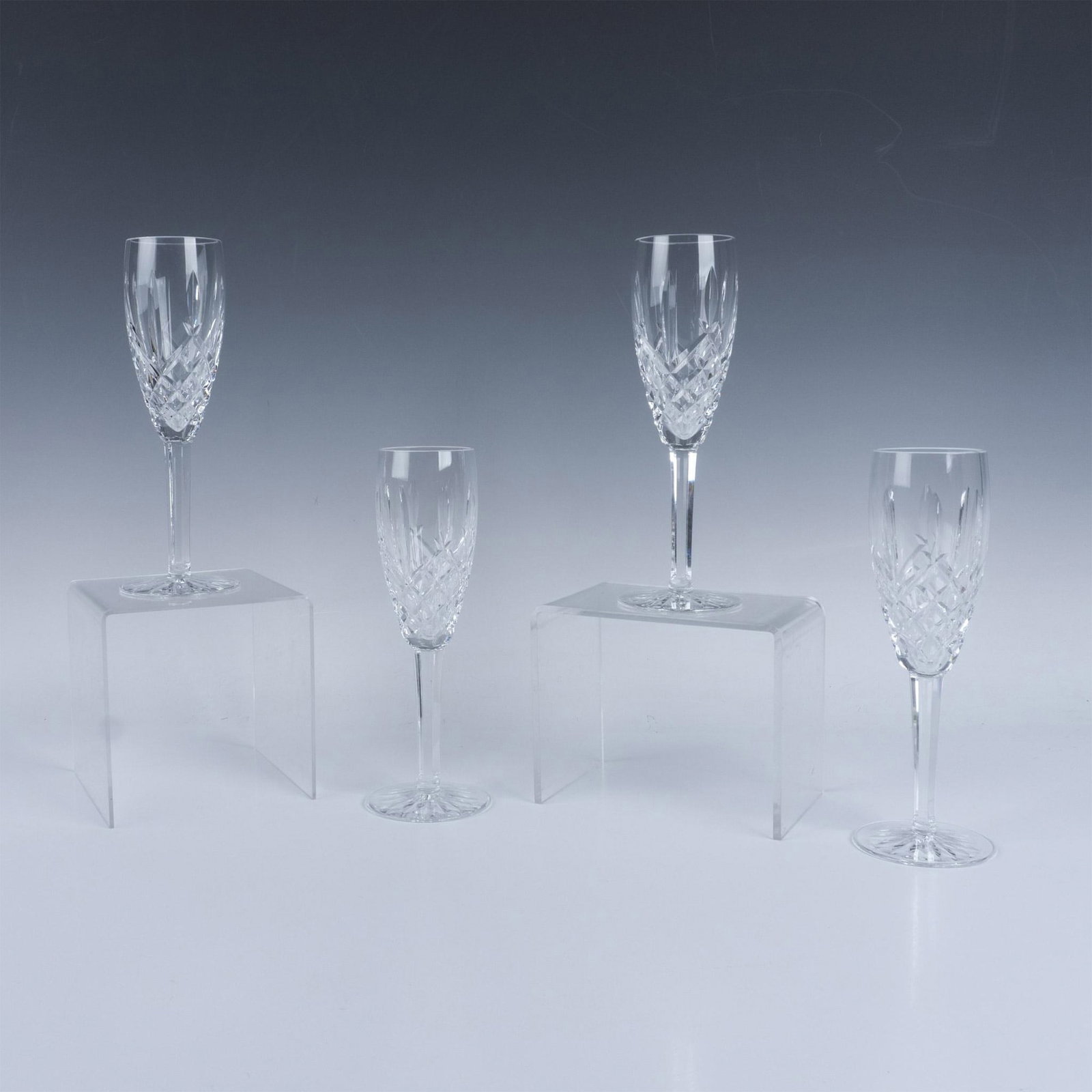 4pc Waterford Crystal Fluted Champagne Glasses, Araglin: Stunning clear crystal decorated in the Araglin cut pattern. Waterford acid mark. Issued: 20th century Dimensions: 8.5''H x 2.75''dia, Each Manufacturer: Waterford Country of Origin: Ireland