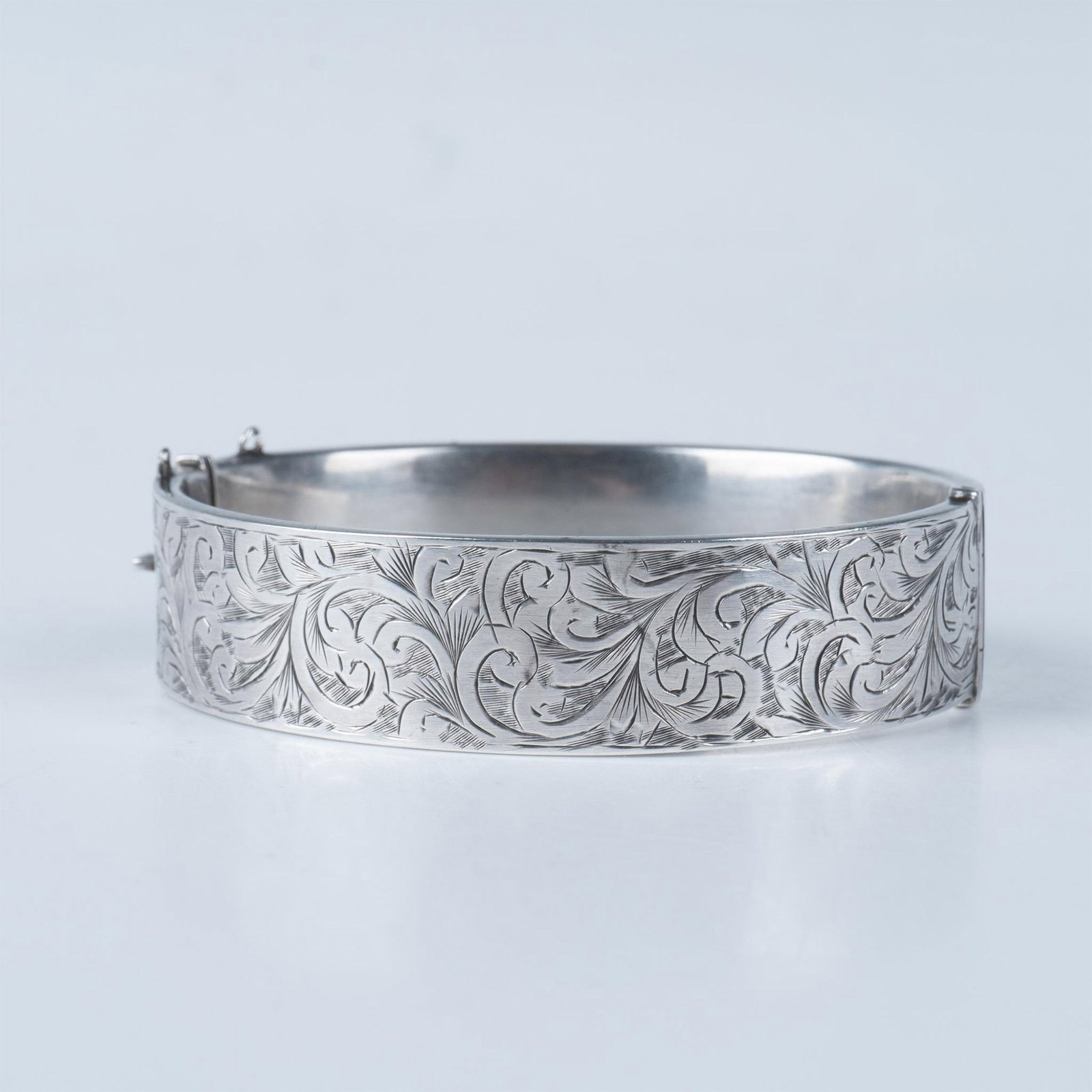 Victorian Style Sterling Silver Bangle: Beautiful Bangle with a Victorian style motif engraving. Weighs 22g. Issued: 20th century Dimensions: 2.75"L x 2.25"W x 0.75"H