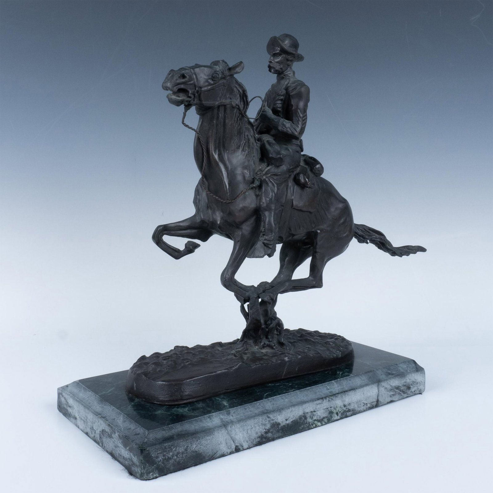 Frederic Remington Bronze Sculpture, Trooper of the Plains: Majestic small bronze sculpture of a mustachioed man with pistol in hand, pressed against his chest, dashing on the back of his horse. Weight is 23.2lbs. Frederic Remington engraved. Artist: Frederic 