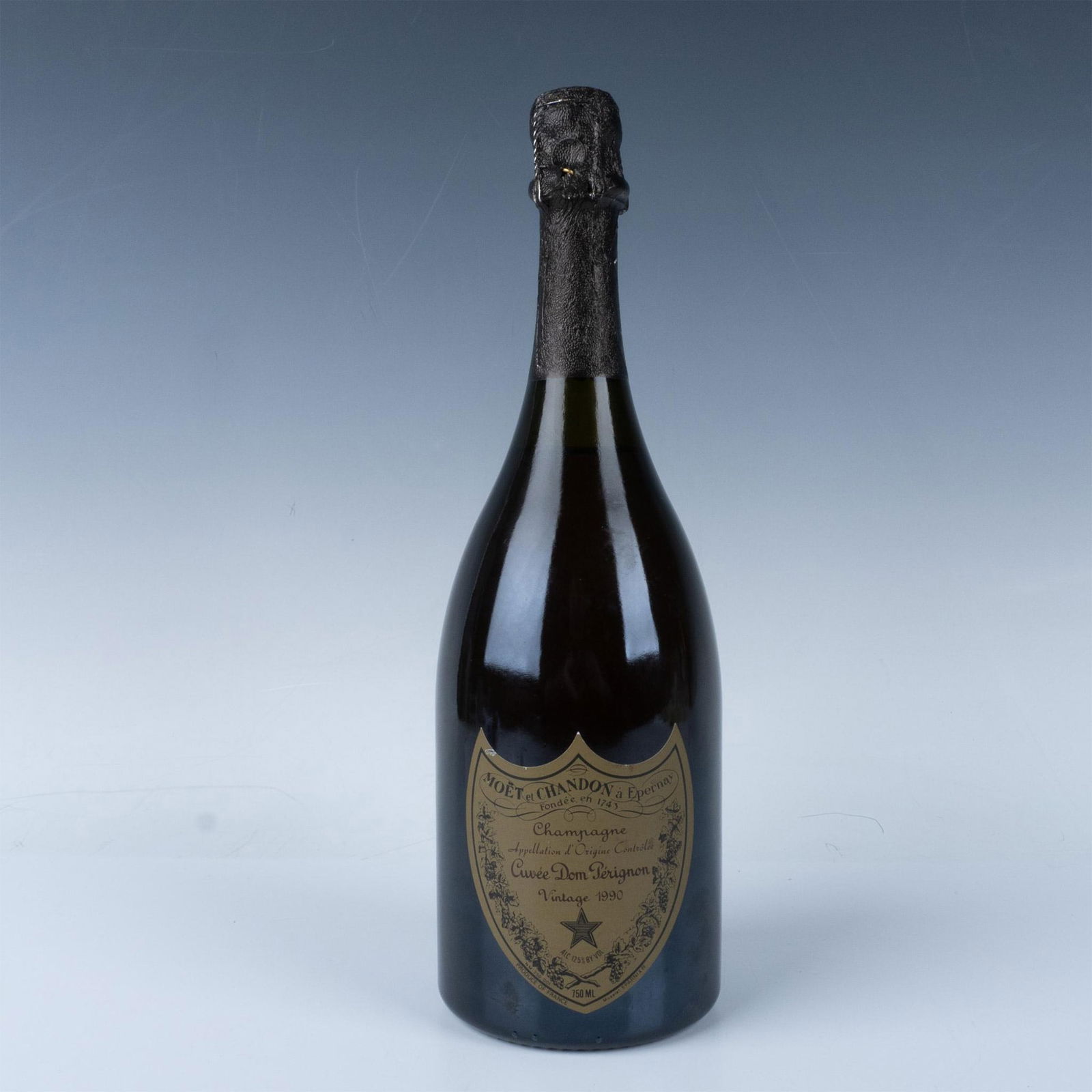 Cuvee Dom Perignon Champagne, Vintage 1990: 750ml bottle, unopened with original labels. Issued: 1990 Dimensions: 12"H x 3.75"dia. Manufacturer: Dom Perignon Country of Origin: France