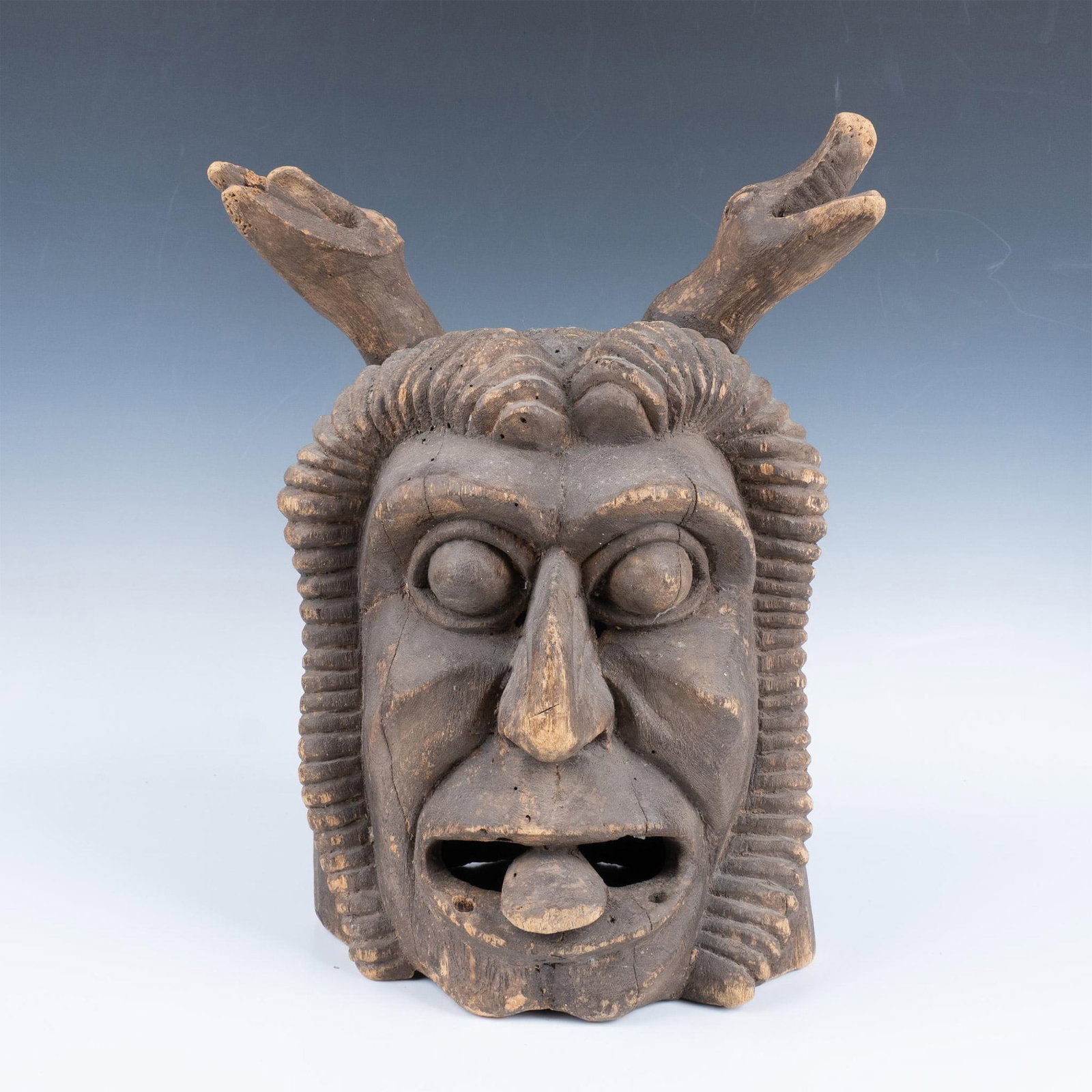 Carved Rustic Wooden Mask: Snake horned demon styled mask with bulging eyes and tongue protruded. Issued: 20th century Dimensions: 11.5"L x 10"W x 16.5"H