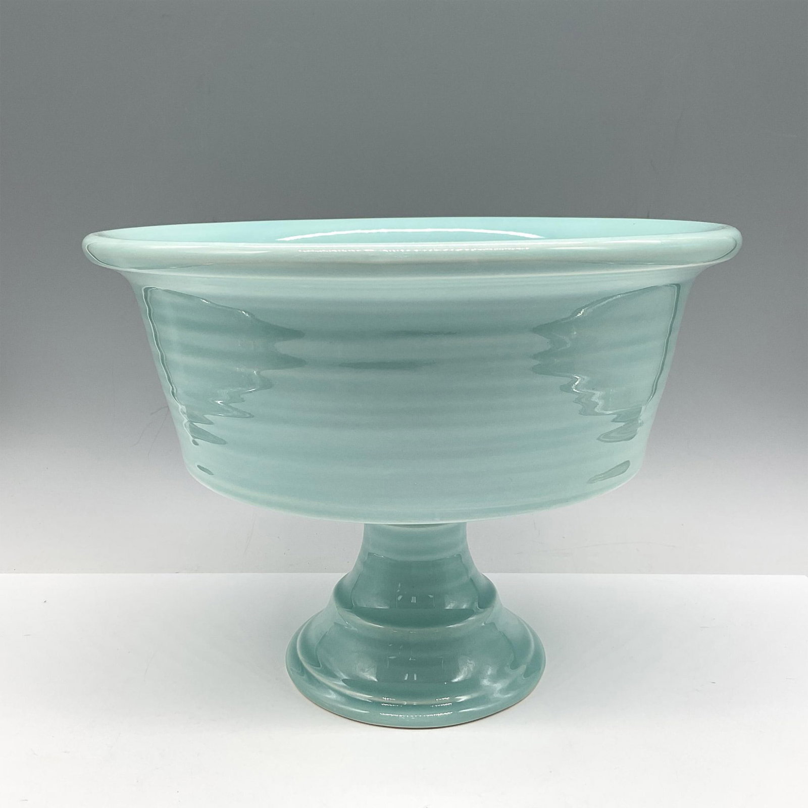 Destinos Ceramic Compote Bowl: Spun ceramic creating ridged appearance. Colored in turquoise on pedestal stacked base. Destinos S.A. Portugal backstamp. Issued: 20th century Dimensions: 7.75"H x 10" dia. Manufacturer: Destinos S.A.