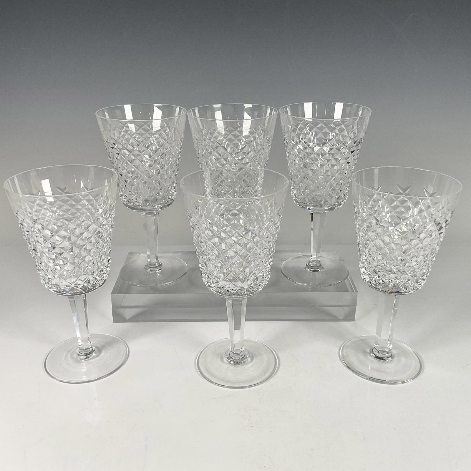 6pc Waterford Crystal Wine Glasses, Alana: Stunning clear crystal set. Features the Waterford Alana pattern creating a beautiful textured and dazzling effect. Waterford acid backstamp. Issued: 20th century Dimensions: 7''H x 3.5''dia, Each Man
