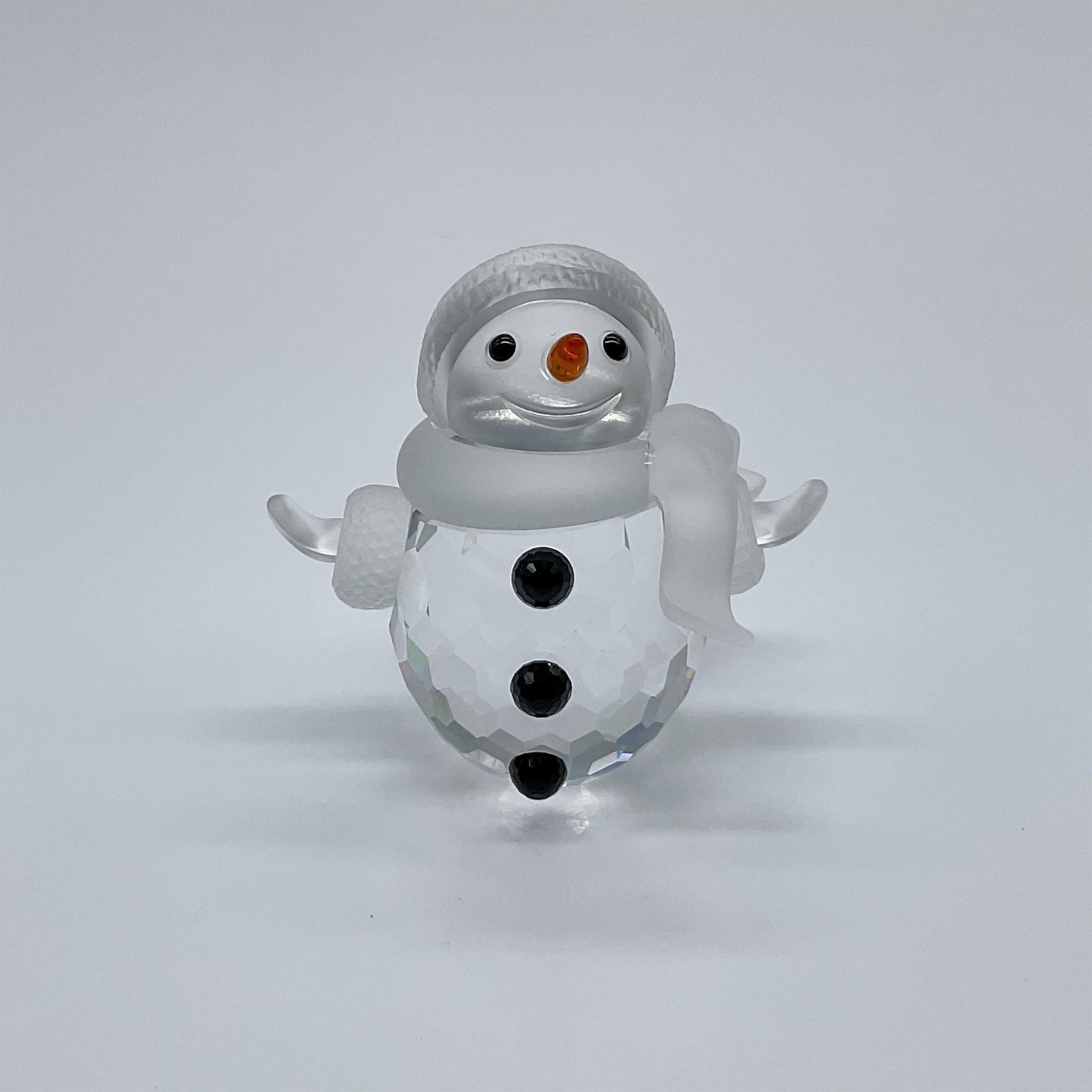 Swarovski Crystal Figurine, Snowman: Originally part of the Cheerful Times collection, then later moved to the When We Were Young collection. A clear crystal snowman with frosted scarf, hat and mittens. The face is frosted with black eye