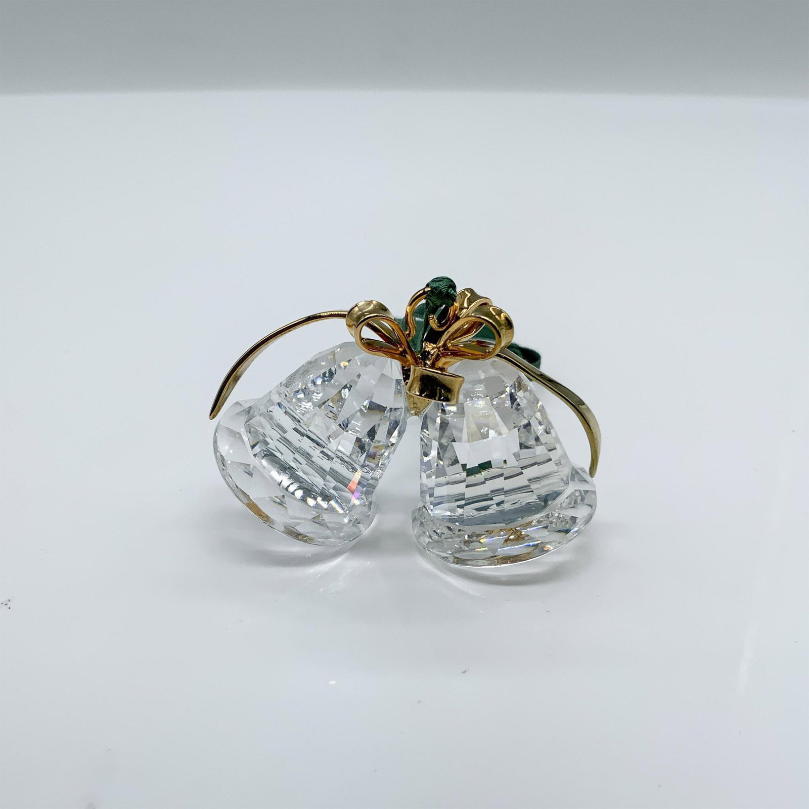 Swarovski Crystal Christmas Ornament, Bells 203079: This retired ornament was part of the Christmas Memories theme grouping. It is clear faceted crystal with gold metal accents. It comes in its original box, which measures 4"L x 4"W x 1.5"H. Artist: Ma
