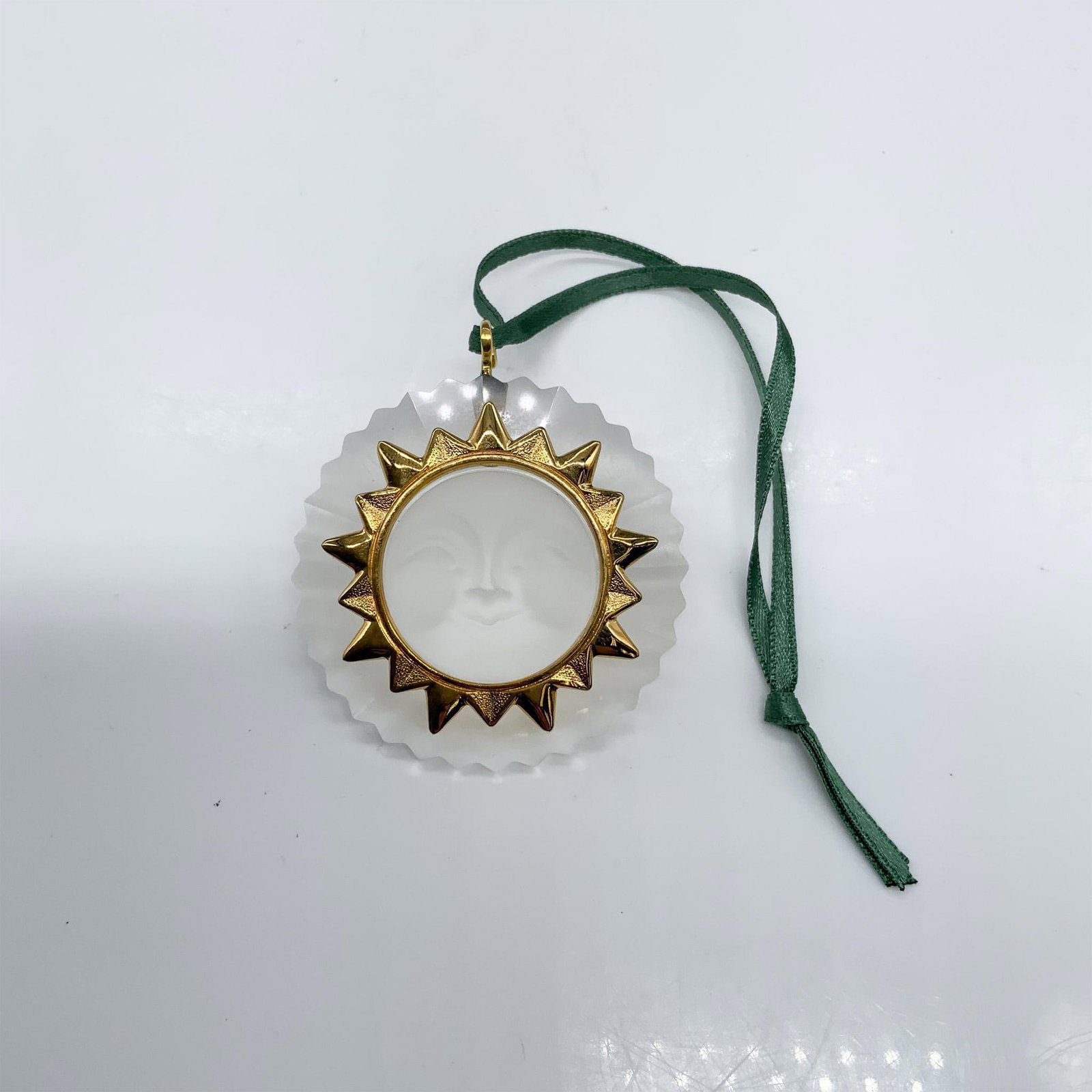 Swarovski Crystal Christmas Ornament, Sun 203082: This retired sun ornament was part of the Christmas Memories theme grouping. It is clear and frosted crystal with gold metal accents. It comes in its original box, which measures 4"L x 4"W x 1.5"H. Ar