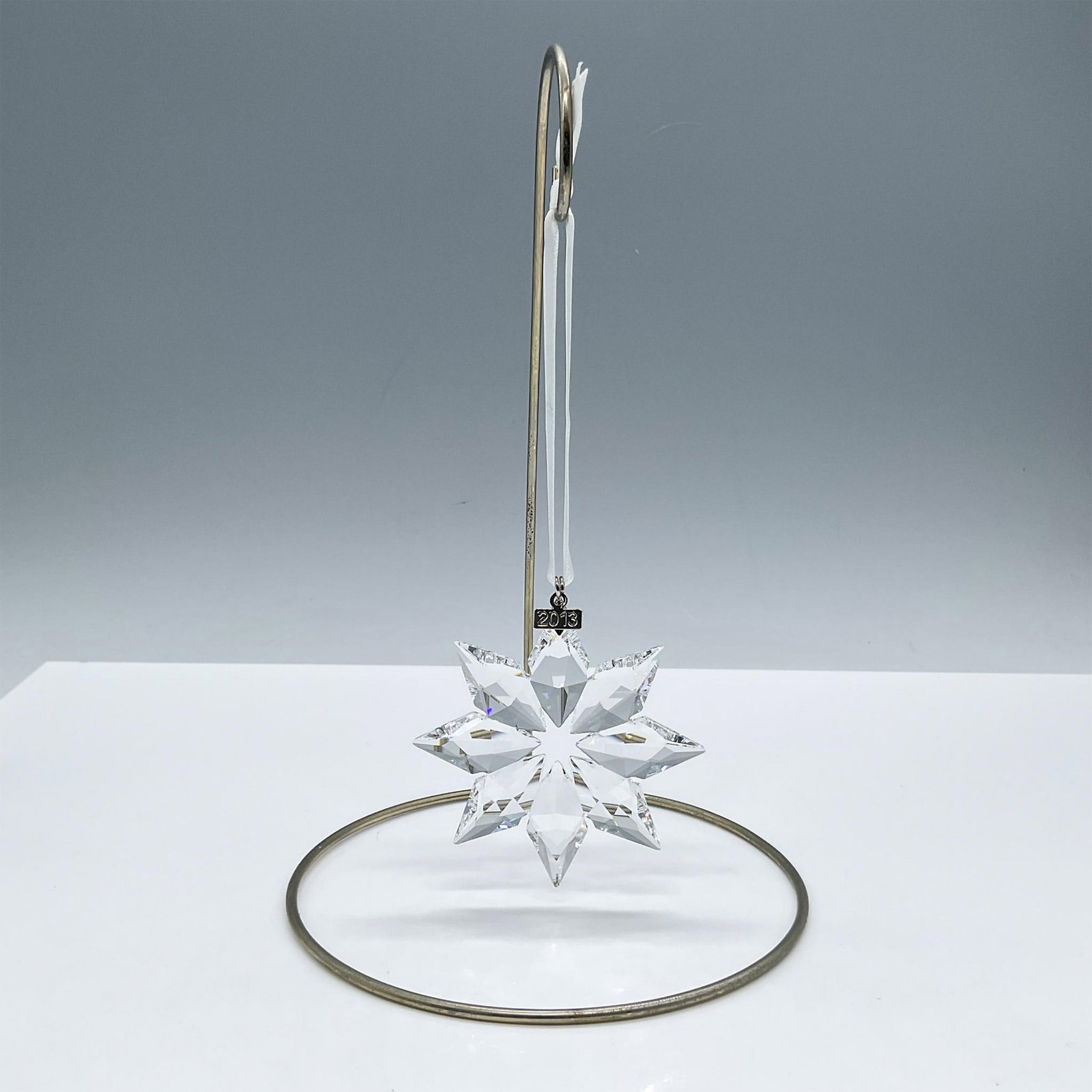 Swarovski Crystal Ornament, Christmas 2013: Stunning clear crystal ornament. Boasts a detailed faceted design, enhancing its light-reflecting properties. Includes the original box, dimensions: 1''L x 6.5''W x 5.5''H. Swarovski mark on metal tag