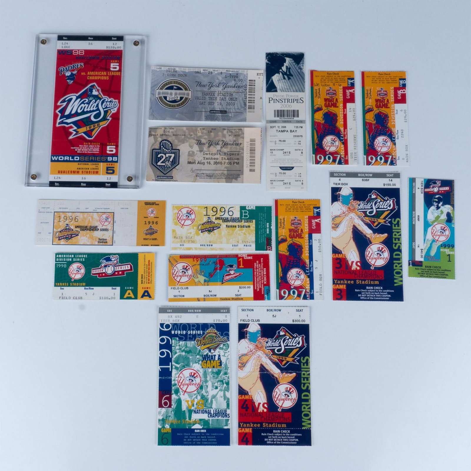 15pc Yankees' Championship Ticket Stubs 1990's and 2000's: This grouping of baseball ticket stubs includes World Series, League Championships, and Yankee Stadium Inaugural Season tickets. Largest piece is in a protective sleeve that measures 8.5"L x 6.25"H. D