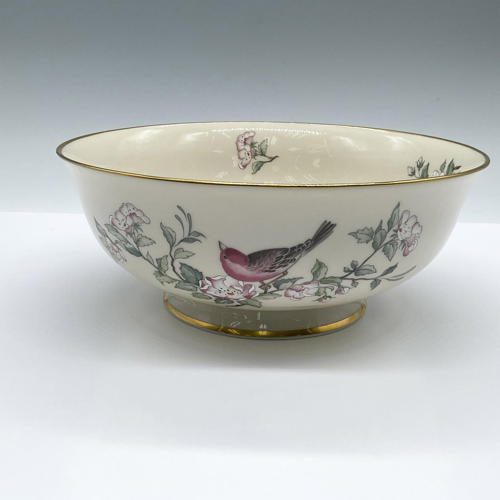 Lenox Porcelain Centerpiece Bowl, Serenade: Cream-colored bowl featuring red birds perched on a pomegranate blossomed branch. Gilt trims. Lenox backstamp. Issued: 1984-1997 Dimensions: 8.75"W x 3.5"H Manufacturer: Lenox Country of Origin: Unite