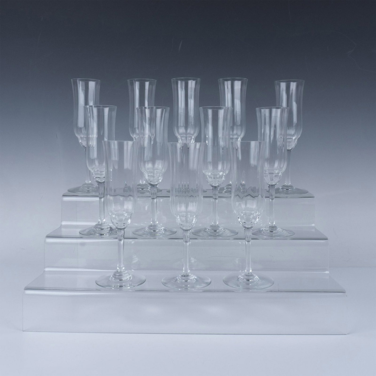 12pc Baccarat Crystal Capri Optic Champagne Flutes: Stunning crystal champagne flutes in the Capri pattern with intricate and slender design. Baccarat etched marking. Dimensions: 3"W x 7.75"H Manufacturer: Baccarat Country of Origin: France