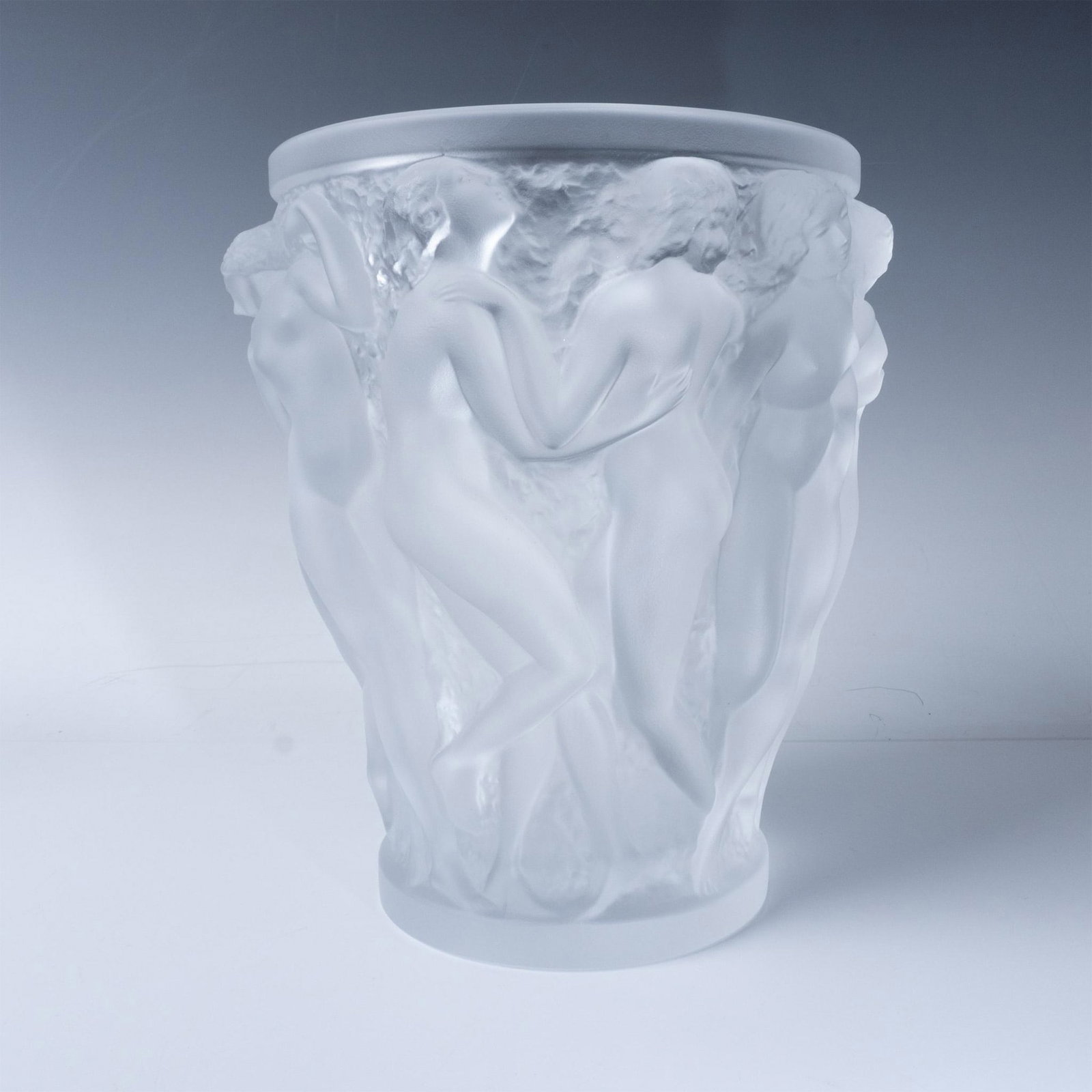 Lalique Crystal Bacchantes Vase: An exquisite vase by Lalique features the Bacchantes design, showcasing the renowned craftsmanship of Lalique. Made from high-quality crystal, the vase is adorned with intricate, sculptural figures of