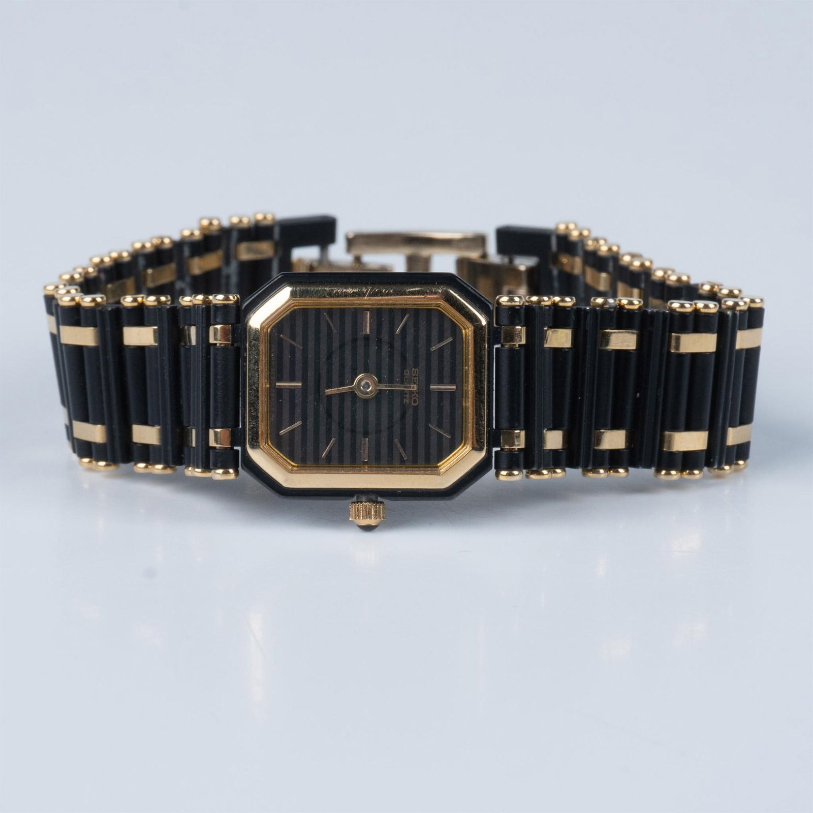 Seiko Quartz Black and Gold Watch 2C20: Japan quartz watch featuring black and gold stainless steel. Dimensions: 7.5"L Manufacturer: Seiko Country of Origin: Japan
