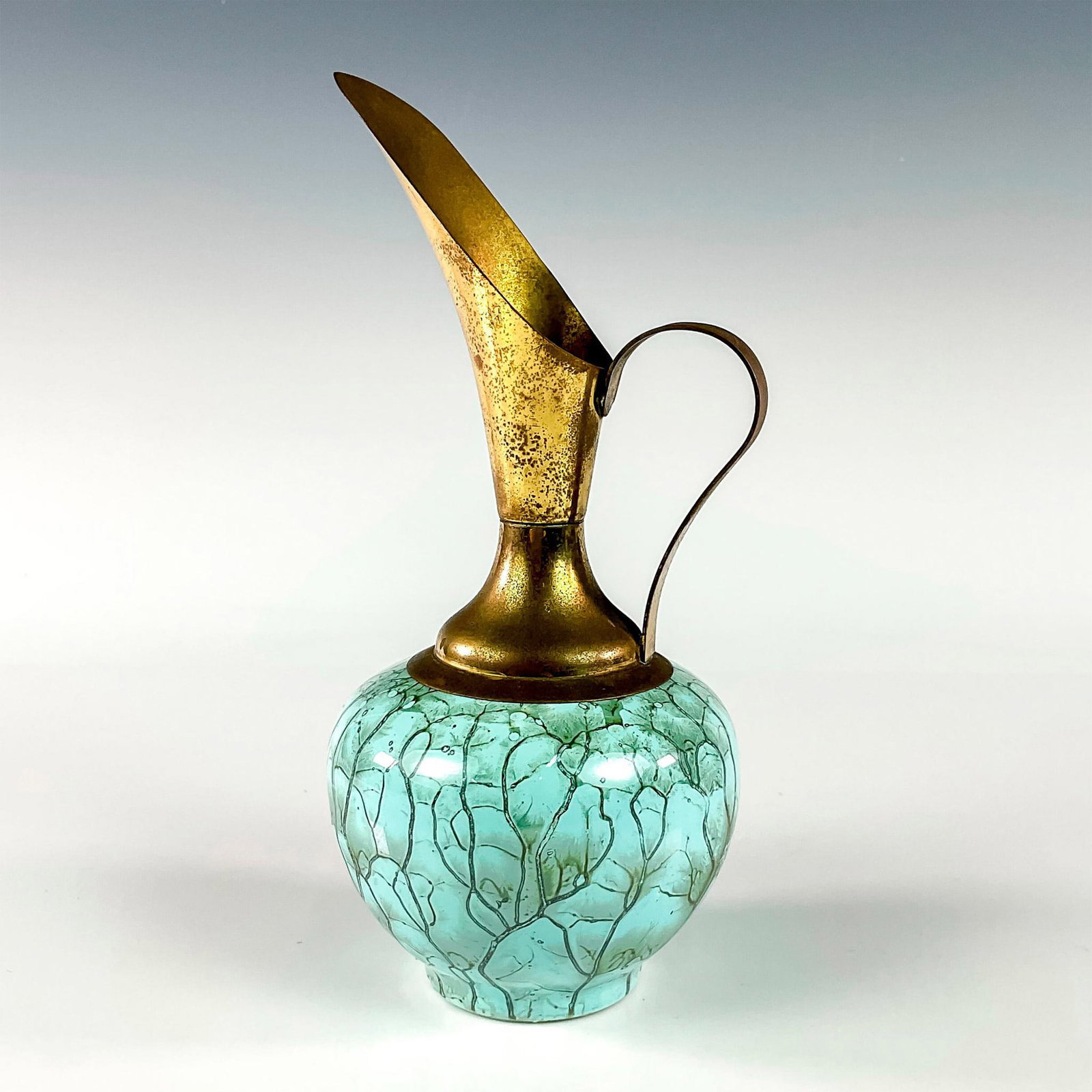 Mid-Century Delft Hand Painted Porcelain Pitcher Brass Vase: Turquoise toned with lustre finish & branch patterning. Brass accented handle and spout. Holland on bottom. This item has no reserve. Dimensions: 3.75"W x 7.75"H Manufacturer: Delft Country of Origin:
