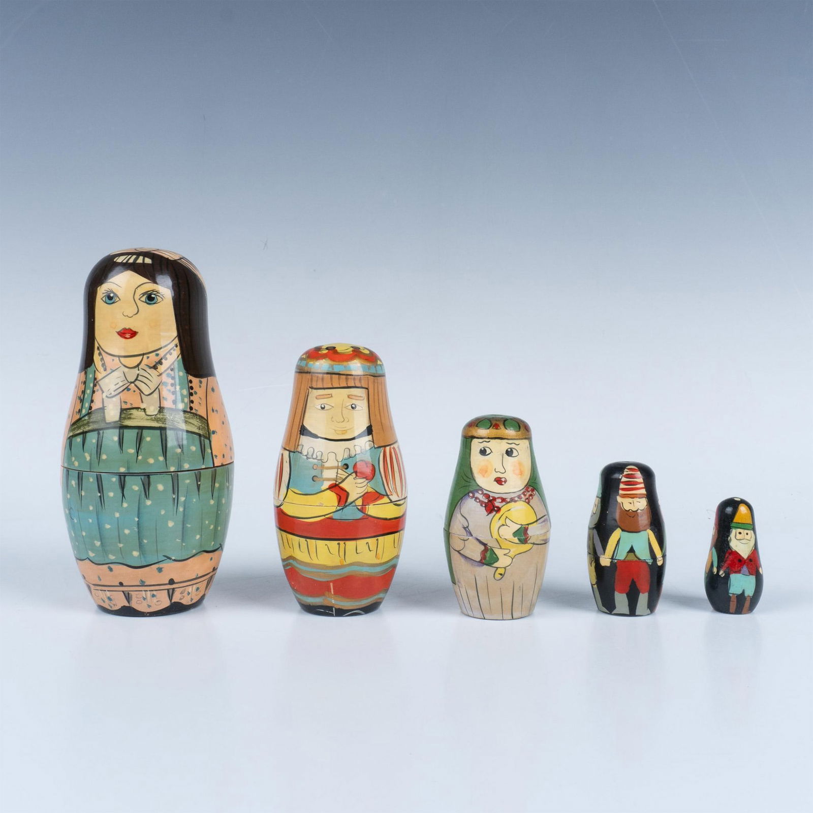 Vintage Russian Nesting Dolls: A set of 5 Russian nesting dolls depicting peasants at work. Largest doll measures 5.5"H x 2.5"dia. Issued: 20th century Dimensions: See Description