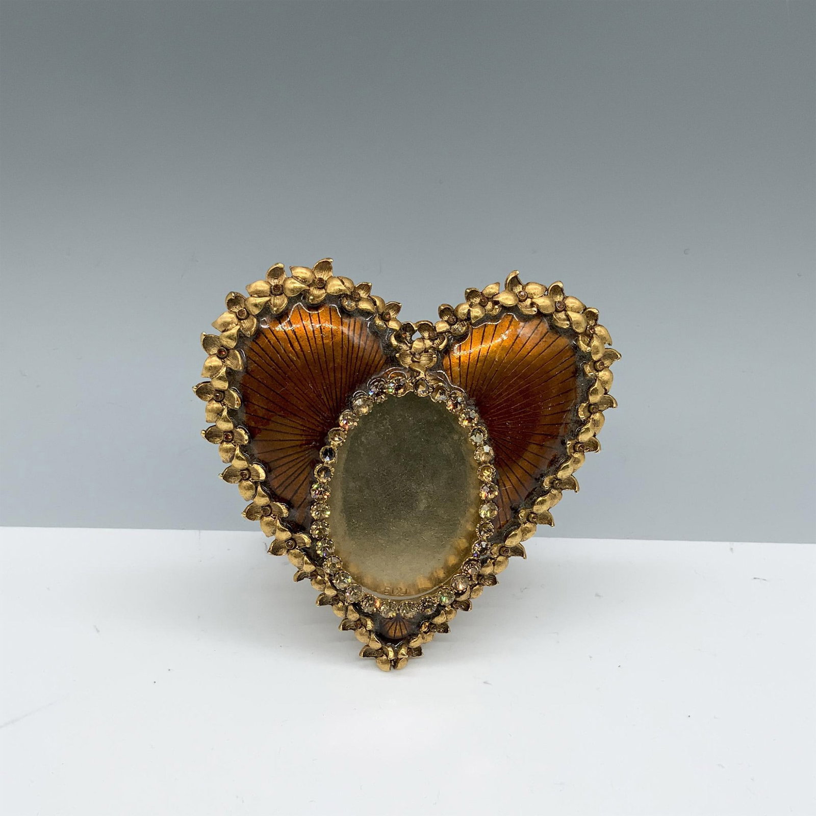 Jay Strongwater Heart Shaped Picture Frame: Lovely mount for photos with an oval panel and floral border. Jay Strongwater backstamp. This item has its original box (8.75"L x 7.75"W x 2.25"H). Dimensions: 4.25"L x 0.5"W x 4.5"H Manufacturer: Jay