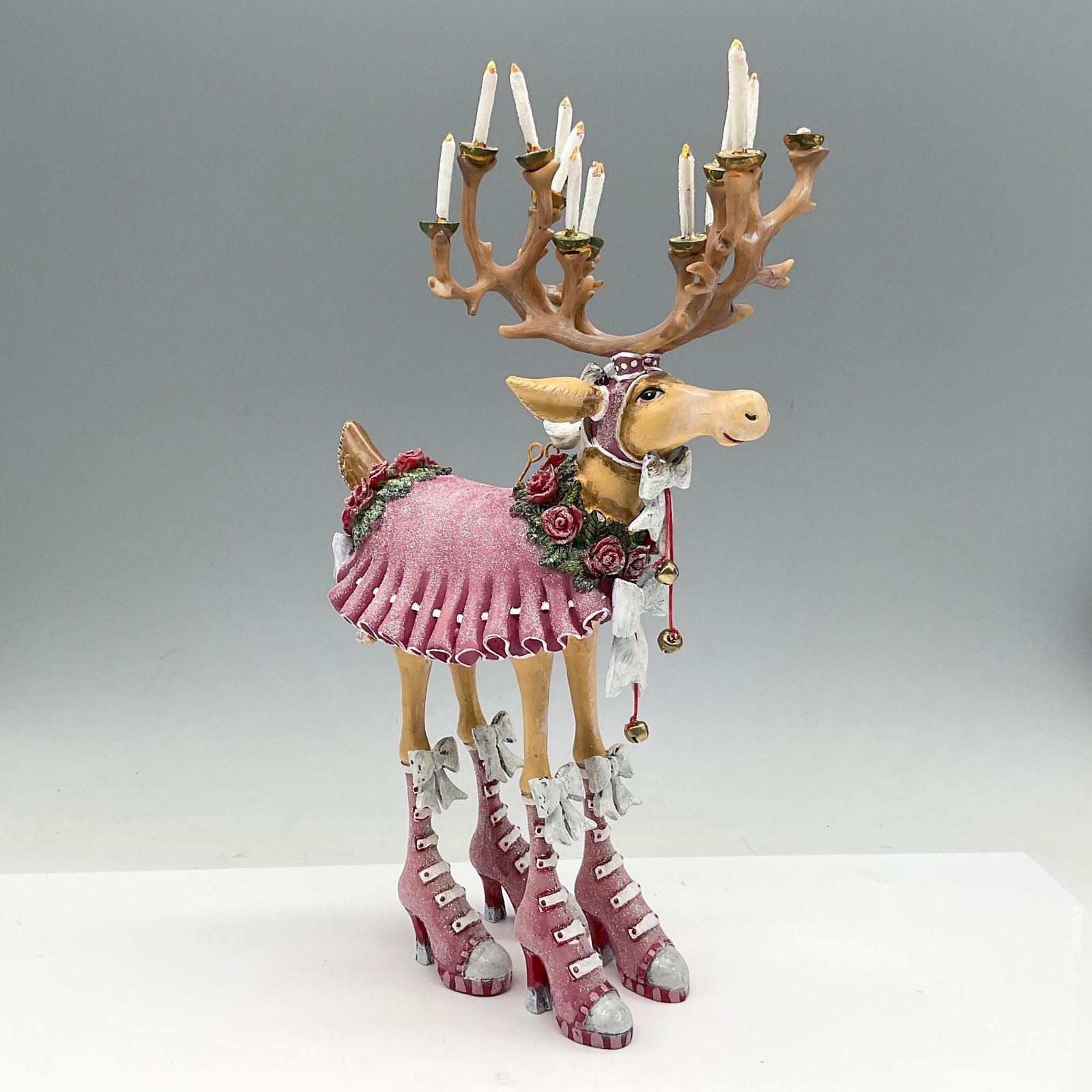 MacKenzie-Childs Patience Brewster, Dash Away Donna: Our playful reindeer is ready for the holiday with candled antlers, bells, flowers, bows and high heels and brightly colored in red and green. Artist: Patience Brewster Issued: 21st century Dimensions