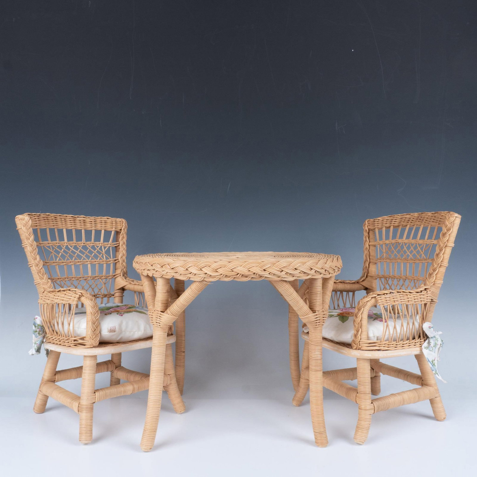 3pc Pleasant Company American Girl Wicker Table and Chairs: As a part of Samantha's birthday collection, an American Girl doll. Largest item measures, 13.25"L x 13.25"W x 10.5"H. Pleasant Company Label on the cushions. American Girl sticker to the underside. I