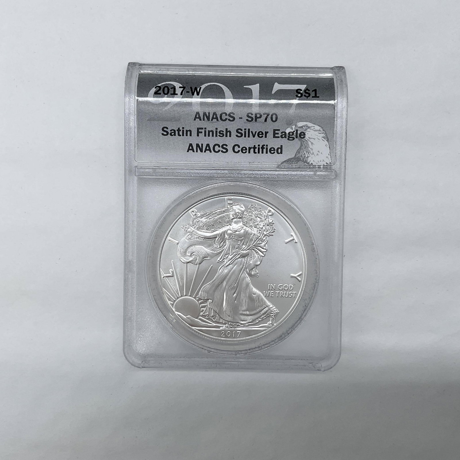 2017-W Silver Eagle Dollar ANACS Graded SP70 Sat. Finish: West Point Mint. Satin Finish. The obverse side depicts Liberty in full stride. She is shown wrapped in the flag, her right hand is extended and her left arm is carrying laurel and oak branches. The r