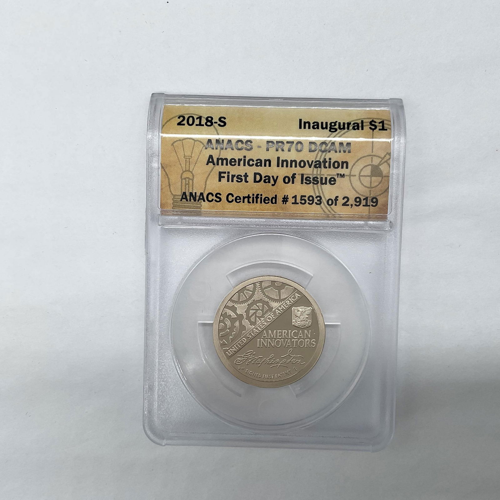 2018-S American Innovation Dollar Coin ANACS Graded PR70 DCAM FDOI: San Francisco Mint. Slabbed PR70 DCAM. First Day Of Issue. Inaugural $1. Certified number 1593 of 2919. The obverse side features the Statue of Liberty in profile. The reverse depicts George Washingto