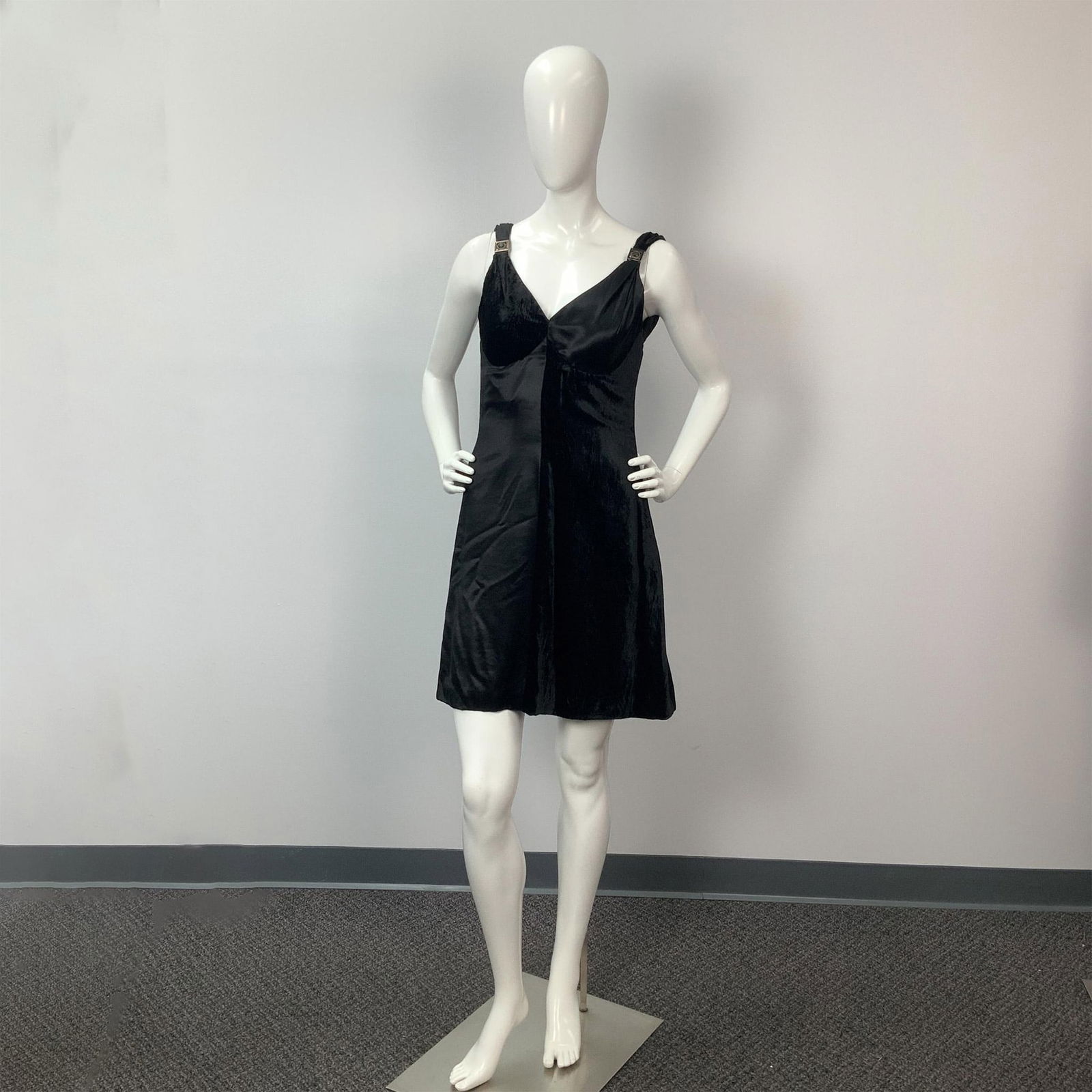 Gianni Versace Black Cocktail Mini Dress: Gianni Versace cocktail mini dress with Black velvet and Black Silk, color blocked design. Back closure with zipper. The Straps have the Versace emblem attached. The interior bodice is fitted with sho