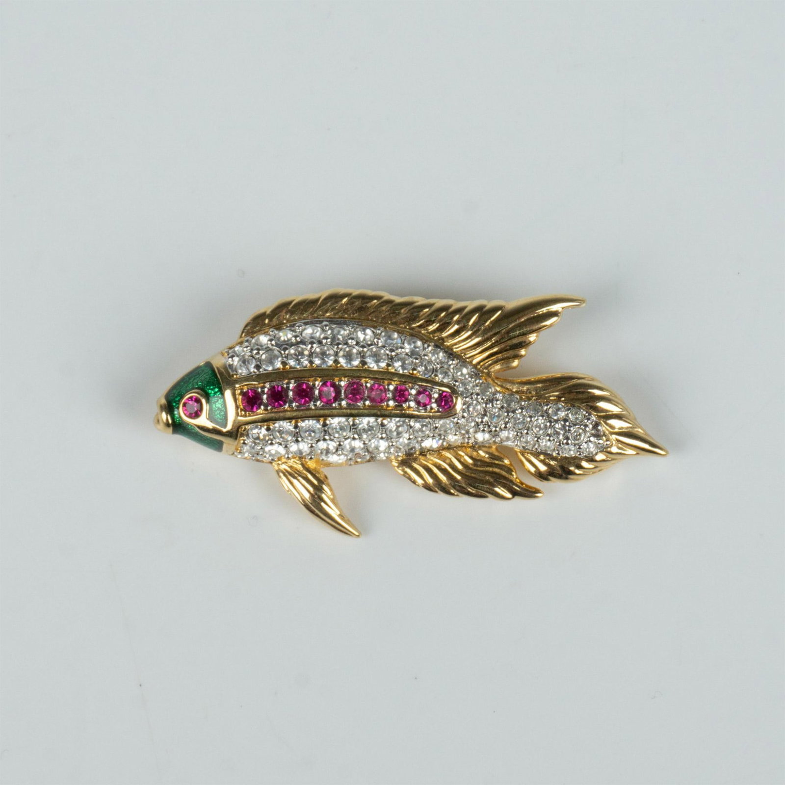 Swarovski Crystal Colorful Fish Brooch Pin: Fabulous gold metal fish brooch featuring a green enameled face with round clear and pink crystals on the body. Swarovski hallmark on the back. Dimensions: 1"L x 2"W Manufacturer: Swarovski Country of