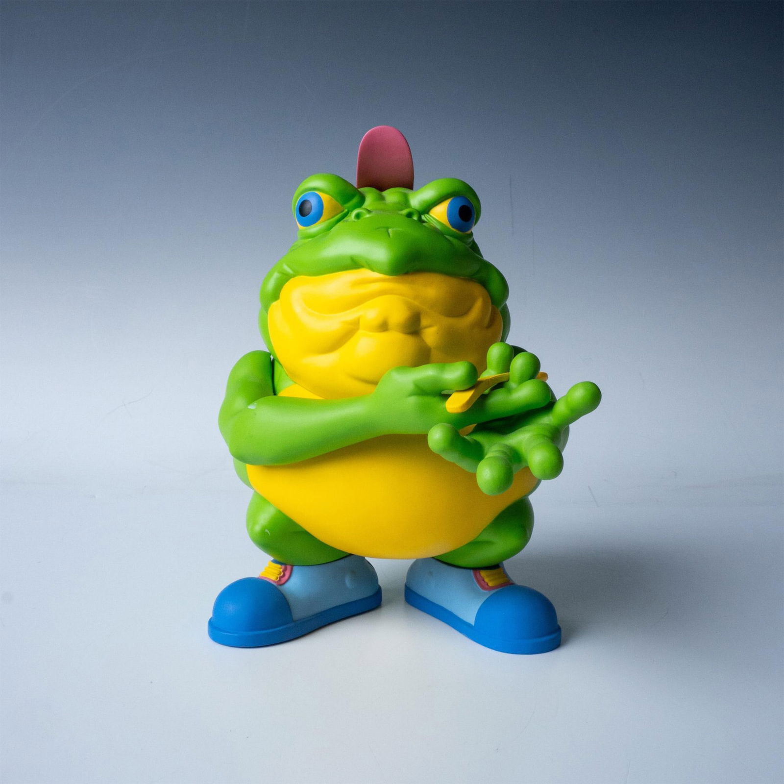 Ron English, Original Drug em Killfrog Figure, Signed: A vibrant green and yellow bullfrog holding a spoon, parodying a mascot for a breakfast cereal. Part of the Cereal Killers Series designed by Ron English. Signed with black marker on the back. Title,