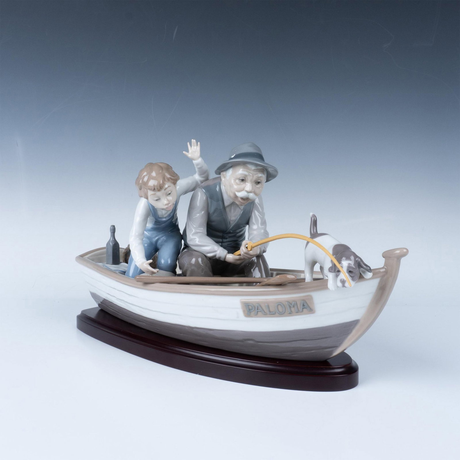 Fishing With Gramps 1005215 - Lladro Porcelain Figurine: Glossy finish; Lladro backstamp. The base measures 13.75"L x 5.25"W x 0.75"H. Artist: Jose Puche Issued: 1984 Dimensions: Approximately 15"L x 6"W x 8.25"H Manufacturer: Lladro Country of Origin: