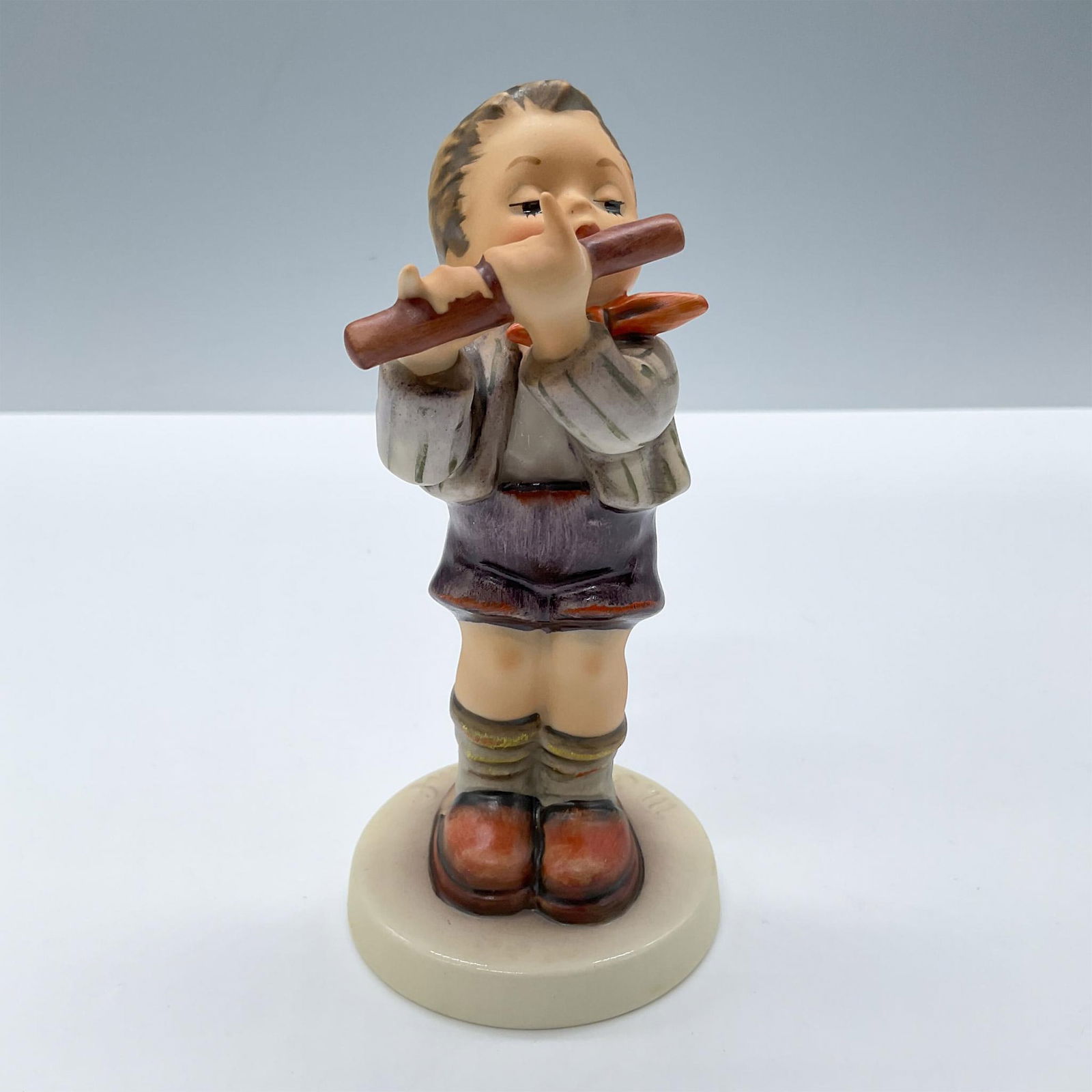 Goebel Hummel Figurine, Morning Concert 447: Features a child playing a flute. Exclusive special edition No 11 For members of the Goebel collectors club. Includes the original box, dimensions:4.5''L x 6''W x 4''H. Goebel Hummel backstamp. Certif