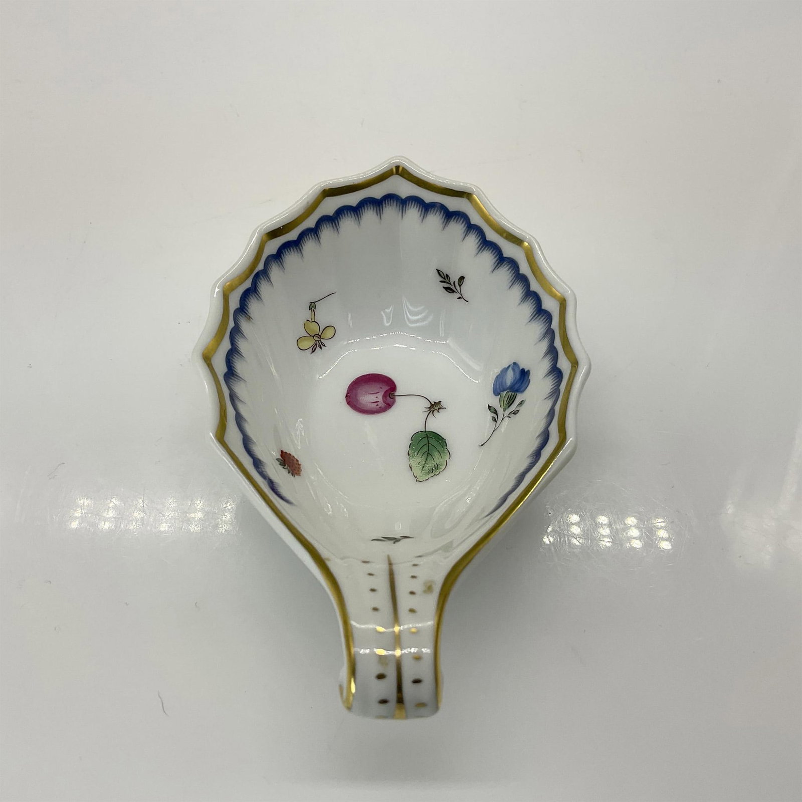 Richard Ginori Porcelain Fruit and Nut Dish: This hand-painted porcelain handled nut dish features the Italian Fruits pattern, showcasing a vibrant fruit and floral motif. The design is accented with a blue cloud scalloped border and lined with 