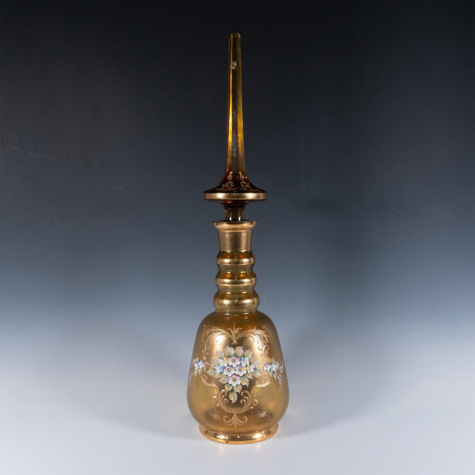 Bohemian Czech Glass Large Bottle: Handcrafted lidded vase featuring intricate gold gilt accents and hand painted floral motifs in high relief. This piece exemplifies the traditional Bohemian glassmaking style known for its high qualit