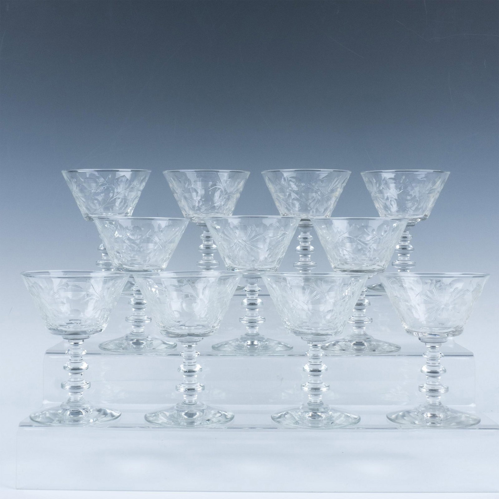11pc Rock Sharpe Wine Glasses: Unique three-ring stem supports the etched glass designed with a floral pattern and topped with a safety lip. Issued: 20th century Dimensions: 5"H x 3.75"dia.
