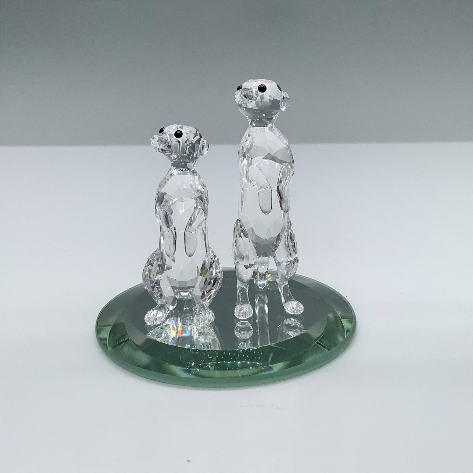Swarovski Crystal Figurine, Meerkats: Adorable piece of two meerkats in their characteristically standing position. One is taller than the other to add tenderness to this wildlife inspired scene. This item has its original box. Box measur